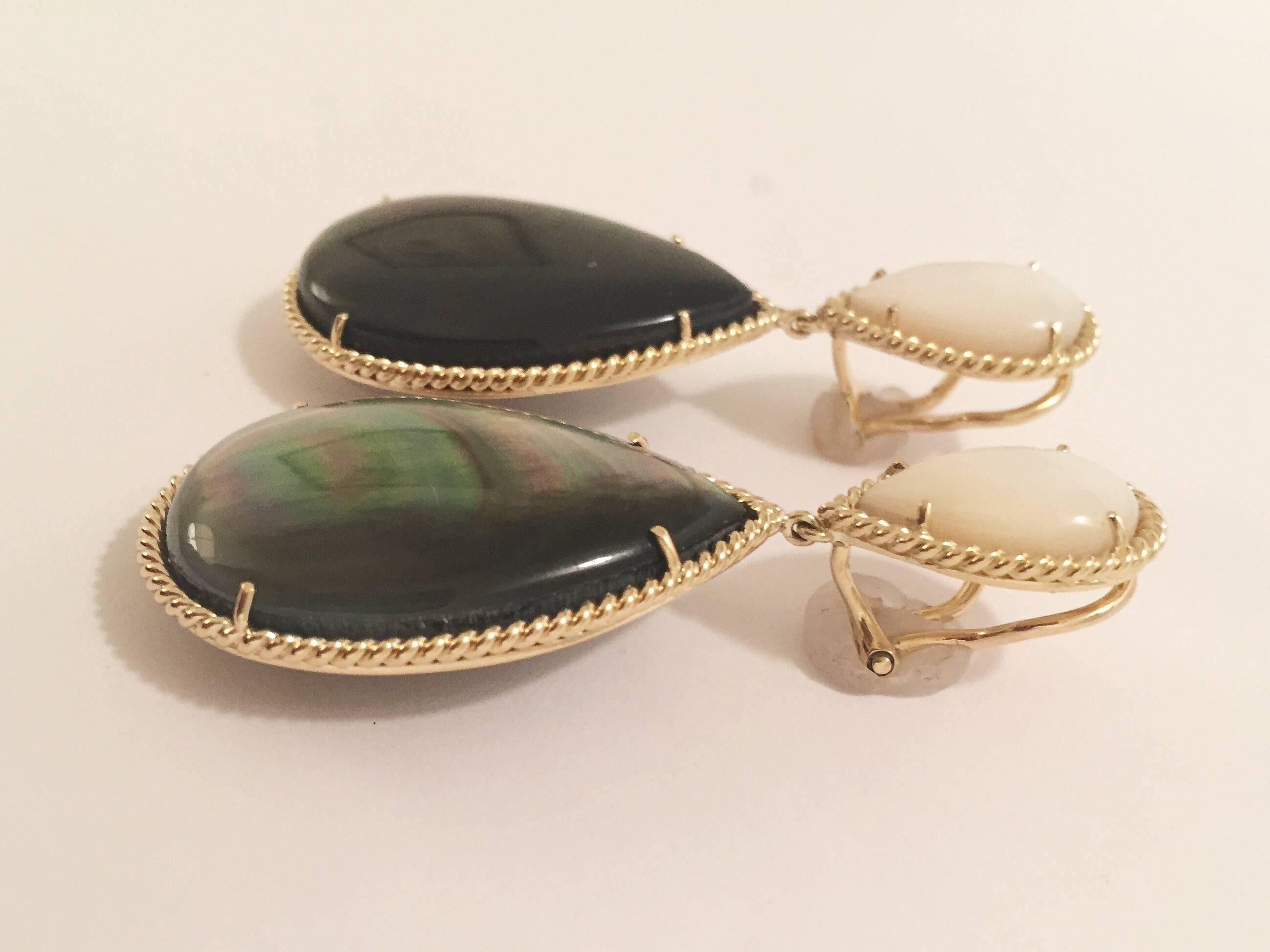 Elegant 18kt Yellow Gold Mother of Pearl and Abalone Drop Earring finished with Twisted Gold Border.  
The earrings measures ~ 2 1/2 inches long and ~ 1 1/8 at it widest point.  
The earring can be made for pieced or clip earrings.  
Please contact