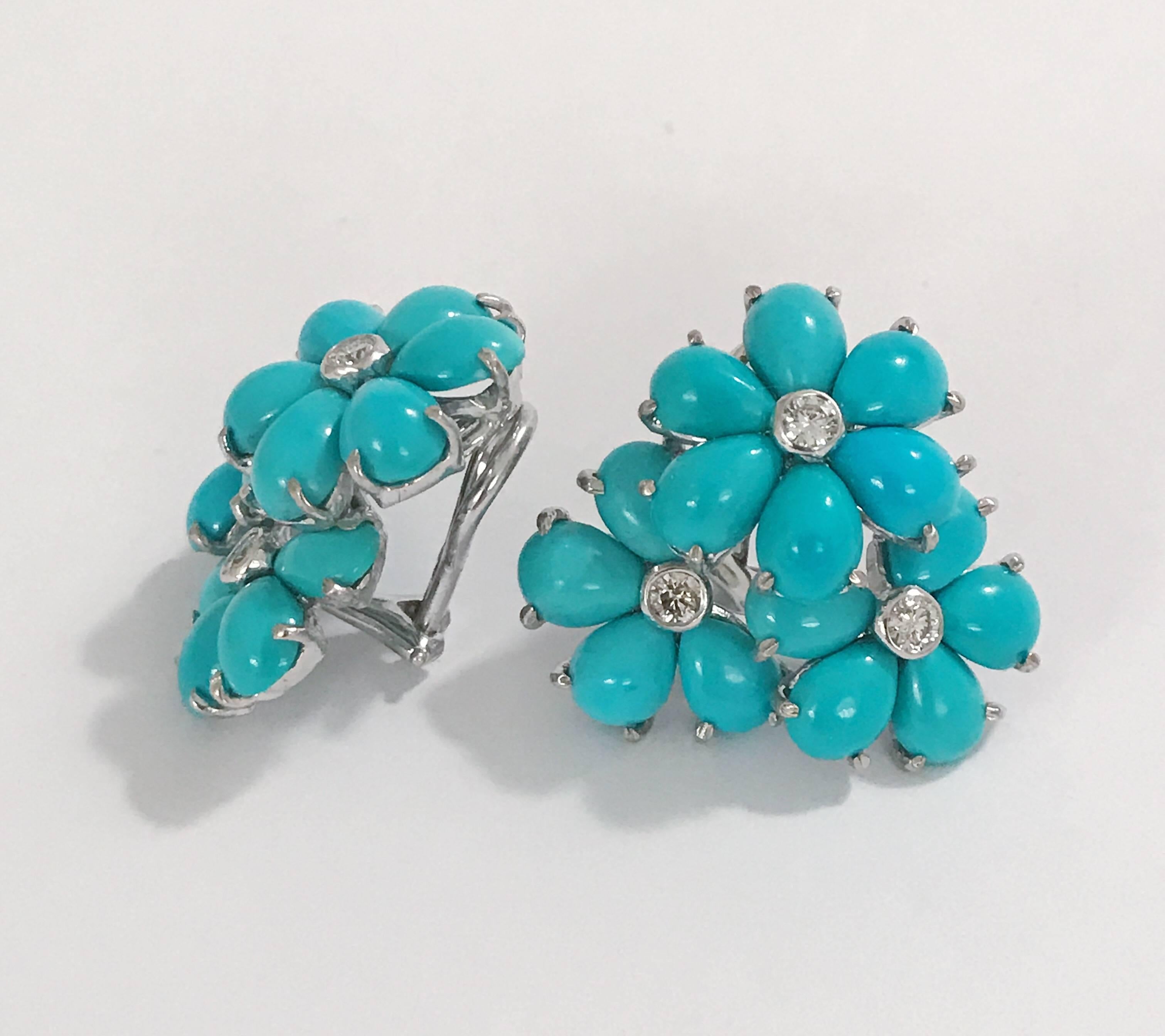 18kt White Gold Turquoise Flower Cluster Earring with Diamonds measures 1 inch across the top and has a height of 1 inch.
 
Approximately the diamond weight between the two earrings is a half of a carat.
Omega clip back.
Can be posted for