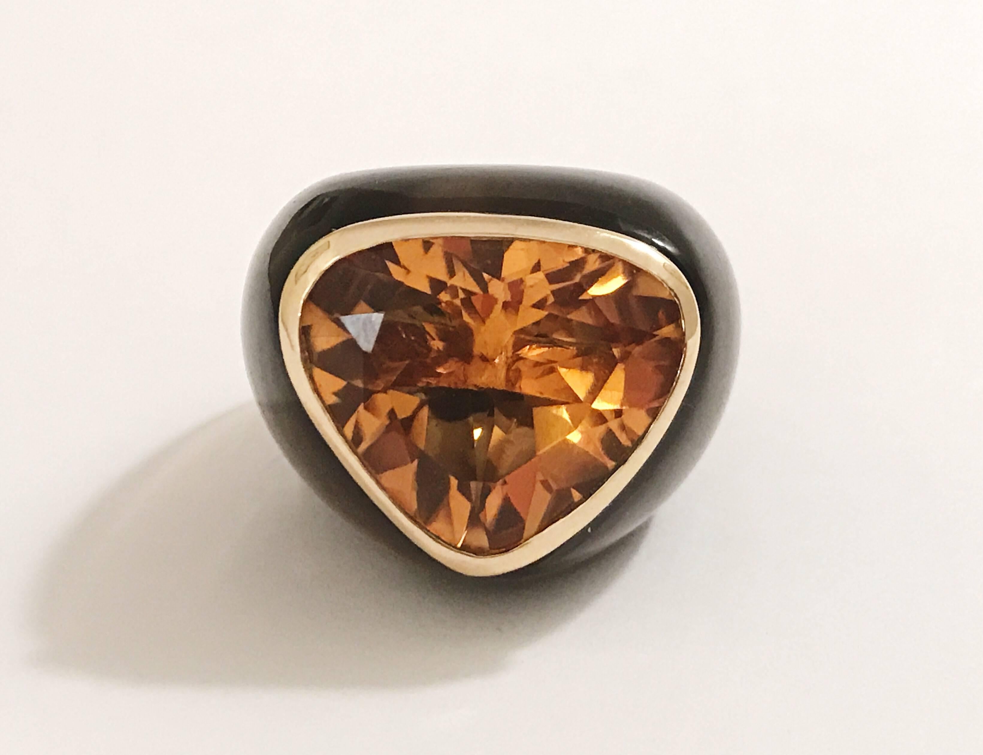 Suzanne Belperron Earring and Ring Set 

Modern Design with fantastic scale.  This carved Smoky Topaz Suite is set with faceted deep colored Citrines that are bezel set in 18kt Yellow Gold.  The ring is size 6 3/4 but can accomodate other ring