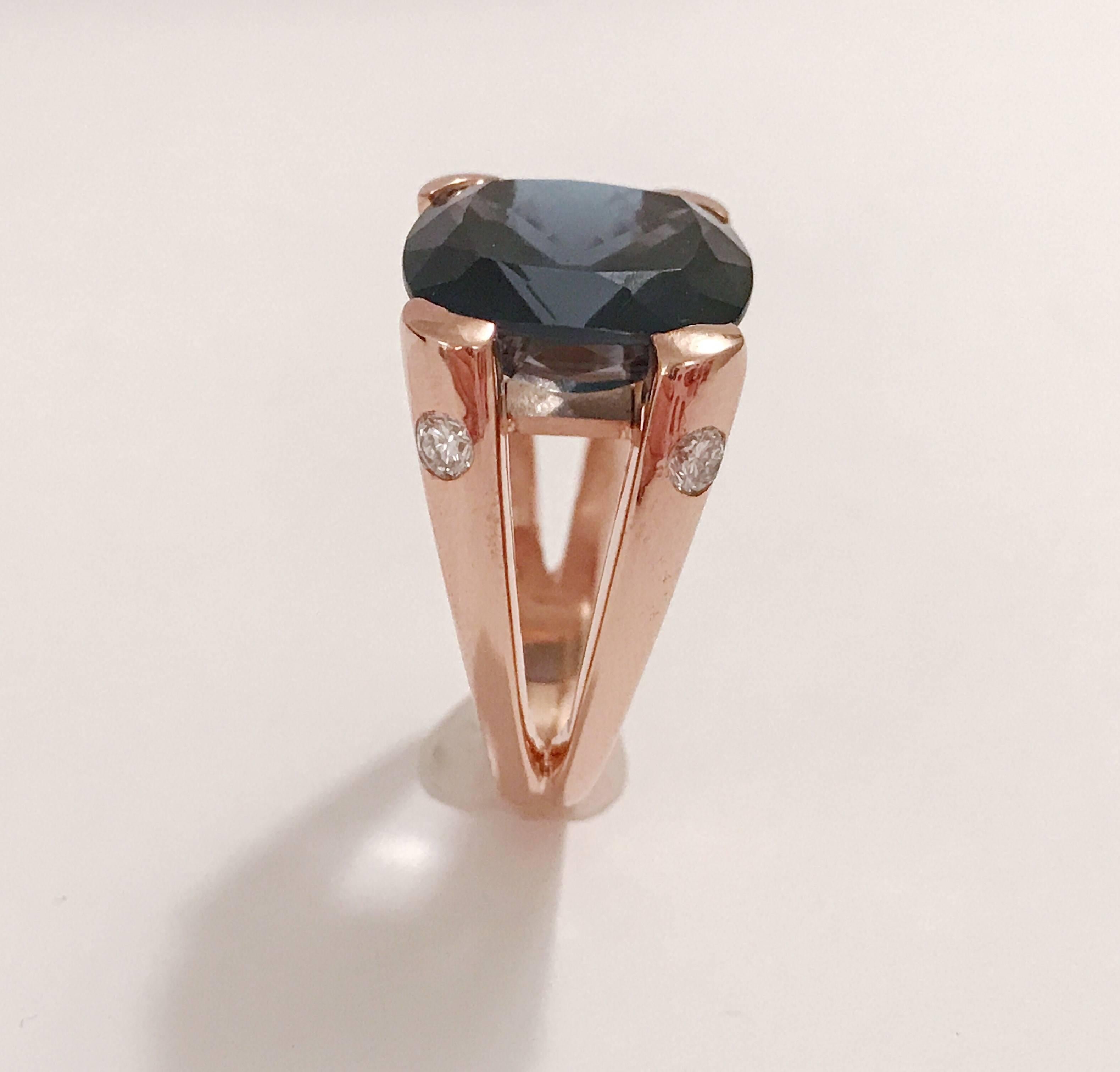 18kt Rose Gold split shank Cushion Ring with 15 mm London Blue Topaz (approximately 25 cts)  and four faceted Diamonds on the side (approximately 0.40 cts).

The elegant split shank add femininity to the boldness of the ring.

This ring can be made