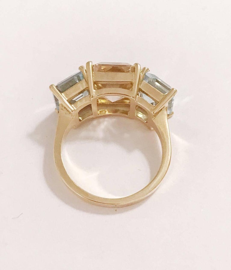 18kt Yellow Gold Mini Emerald Cut Ring with pale pink and blue semi precious zircon (not the synthetic cubic zirconia crystal)  

Zircon occurs in an array of colors. Its varied palette of yellow, green, red, reddish brown, and blue hues makes it a