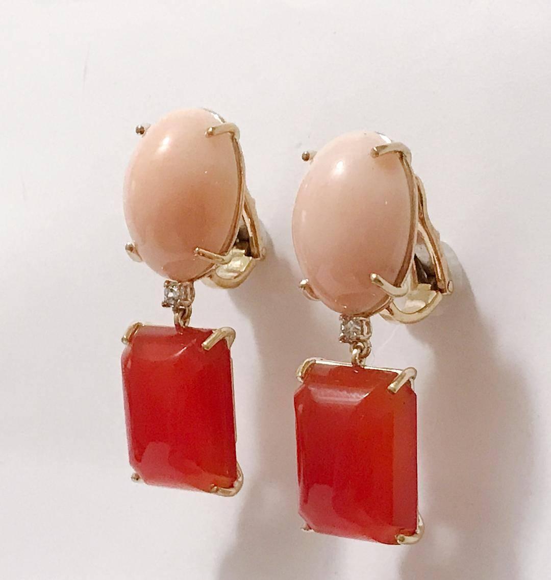 Andrew Clunn Geometric Drop Earring with Oval Coral and Rectangular Carnelian with a center Diamond stone.

18kt Yellow Gold with omega back.

These can be posted or clip on.

Please Let me know if you have any questions.
Best,
Christina 