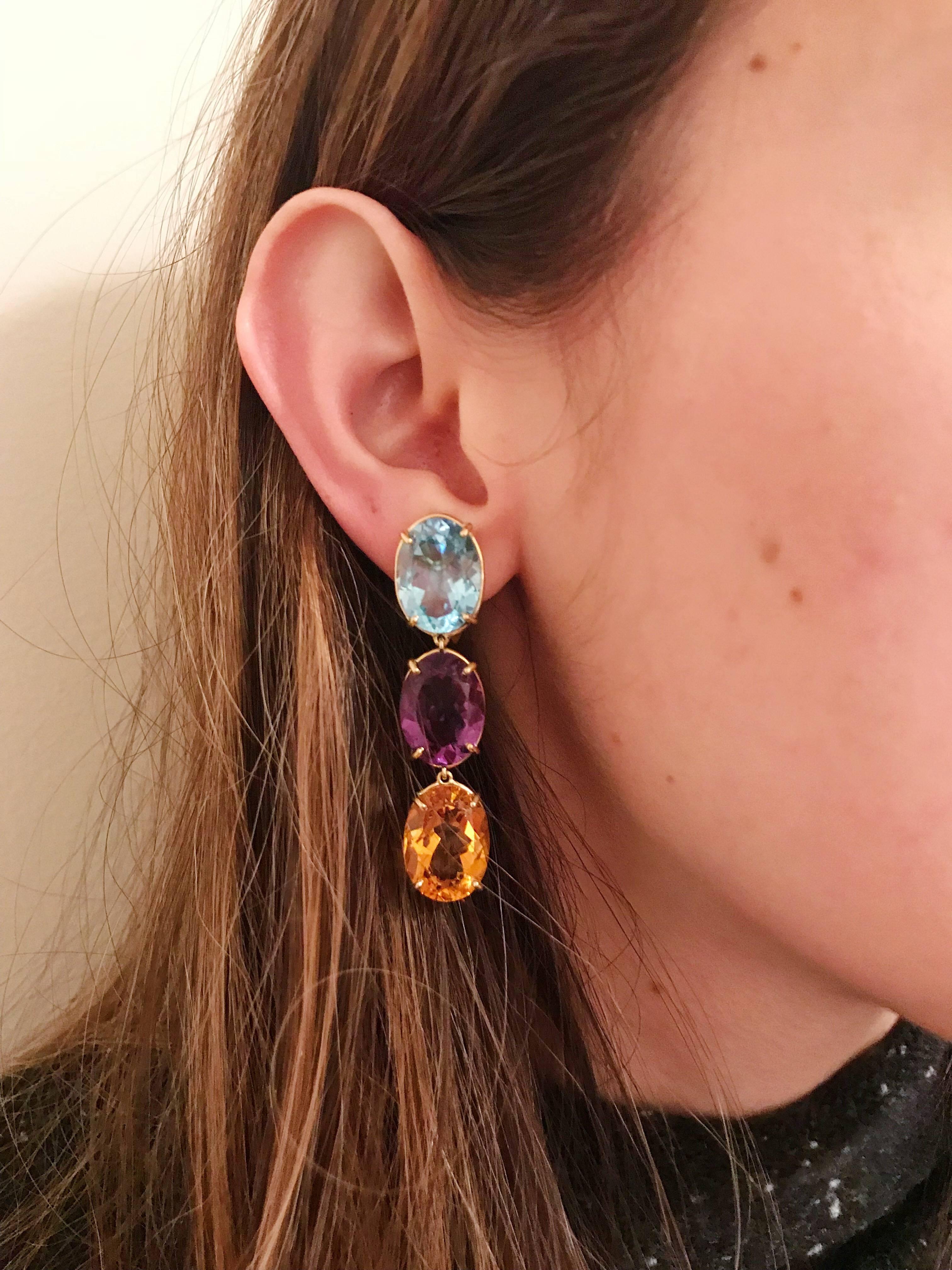 18kt Yellow Gold Elegant Three stone Drop Earrings with faceted oval Blue Topaz, Amethyst and Citrine.  

The Earrings measure  2 1/4 in length.

The earrings can be made for Clip Earring or Pierced Earrings.

They can also be custom made with and