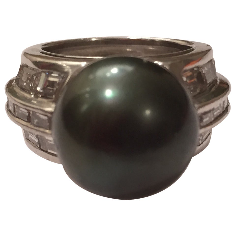 Andrew Clunn Elegant Platinum Baguette Diamond and South Sea Pearl Ring with South Sea Black pearl measuring 13.5mm .

The pearl is mounted in three rows of baguette diamonds weighing ~2.80cts.  

This ring can be sized.

Please contact us with any