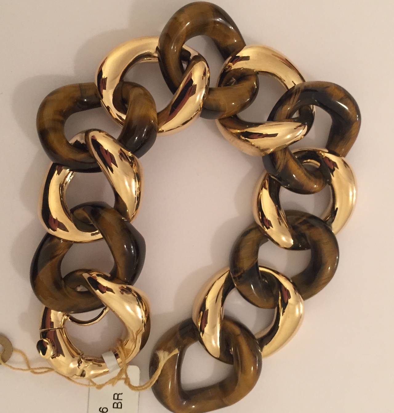 Elegant 18kt Yellow Gold and Tigers eye curved link bracelet with self link closure.  The fabulous bracelet measure 7 1/2 inches but can be made to any measurement.  The gold and Tigers eye links measure approximately 3/4