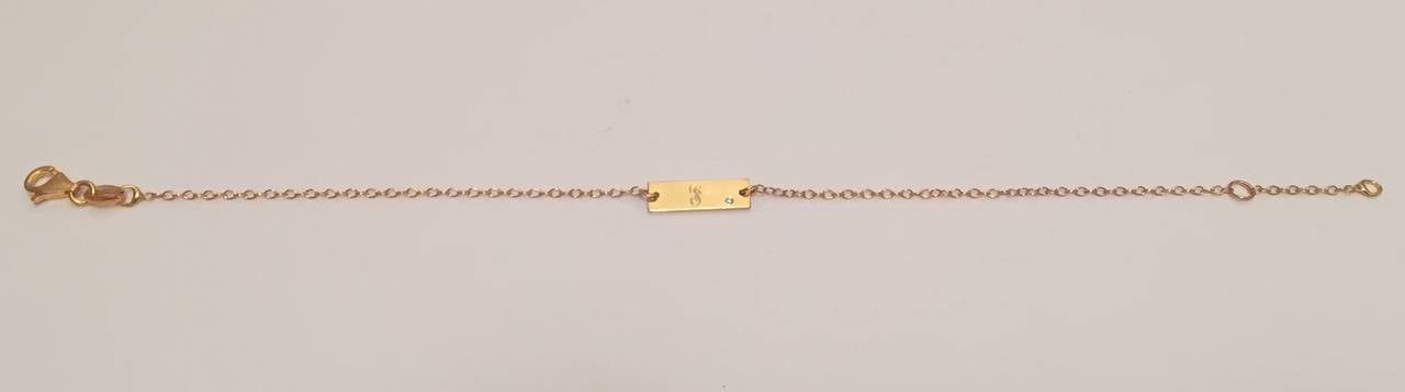 Initial plate bracelet with diamond accent.  Personalize this delicate bracelet with off set diamond accent.  The gold plate is approximately 1/2