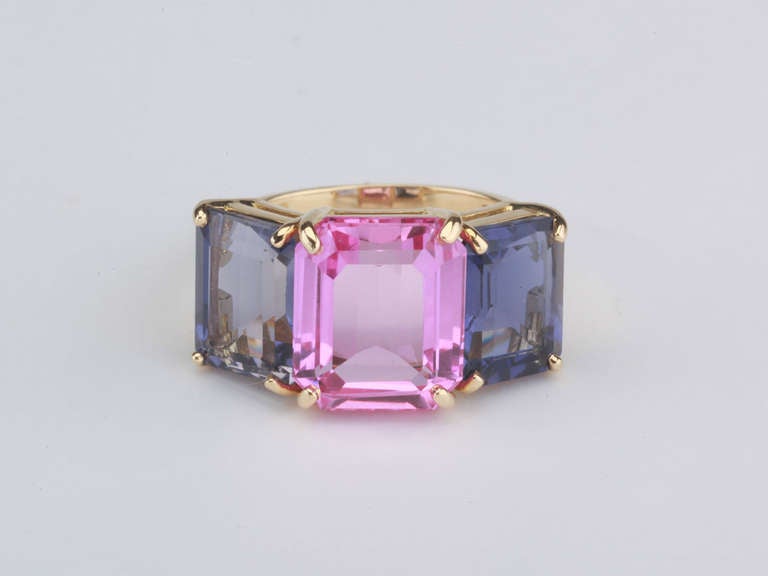 18kt yellow gold Emerald Cut ring with pink topaz (approximately 5 cts) and iolite (approximately 4 cts each).

The Ring measures approximately 1 
