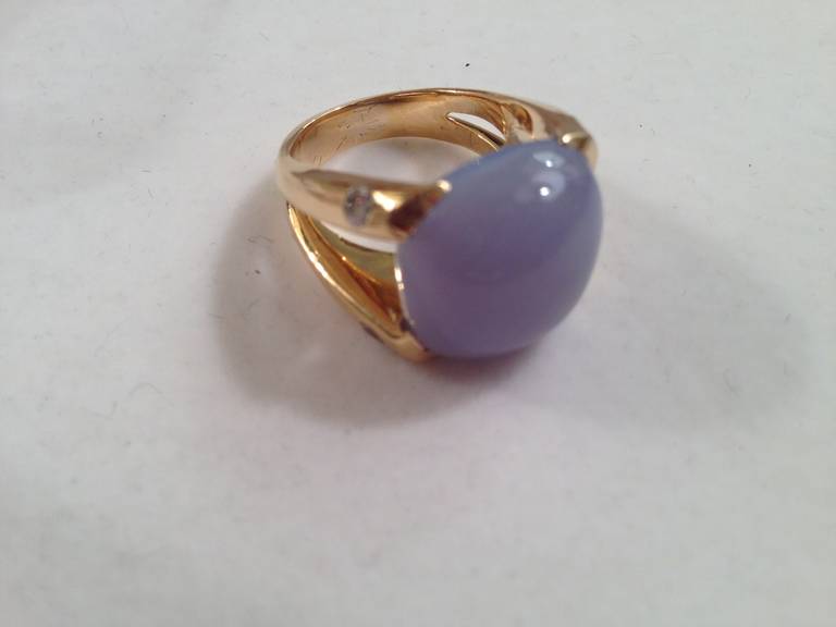 18kt Yellow Gold Cushion Ring with 15mm Cushion cut Cabochon Chalcedony (approximately 25 cts)  and 4 Diamonds (approximately 0.40 cts).  

Center Cabochon Chalcedony has an offset by the diamond accent stone. The elegant split shank add femininity