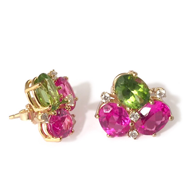 18kt Yellow Gold Pink Topaz, Peridot and Diamond Mini Pebble Earring.

This elegant mini cluster combines faceted oval Pink Topaz and Peridot with the sparkle of 8 diamonds weighing approximately 0.25 cts

The earrings measure 5/8
