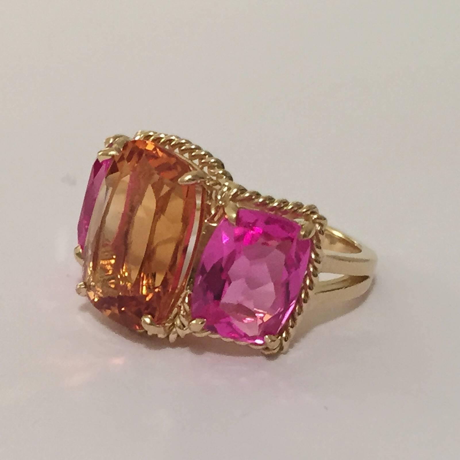 Elegant 18kt Yellow Gold Three Stone Ring with Citrine, Pink Topaz and Rope Twist Border with split shank detail. The ring features three faceted cushion cut stones surrounded by twisted gold rope. The center Citrine stone measures 5/8