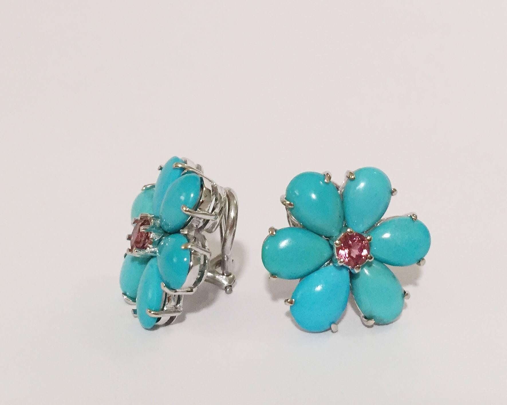 18kt White Gold Turquoise Flower Earring with 12 Pear shaped print set Turquoise surrounding a print set Faceted Rubellite Center.

The earrings measure 3/4