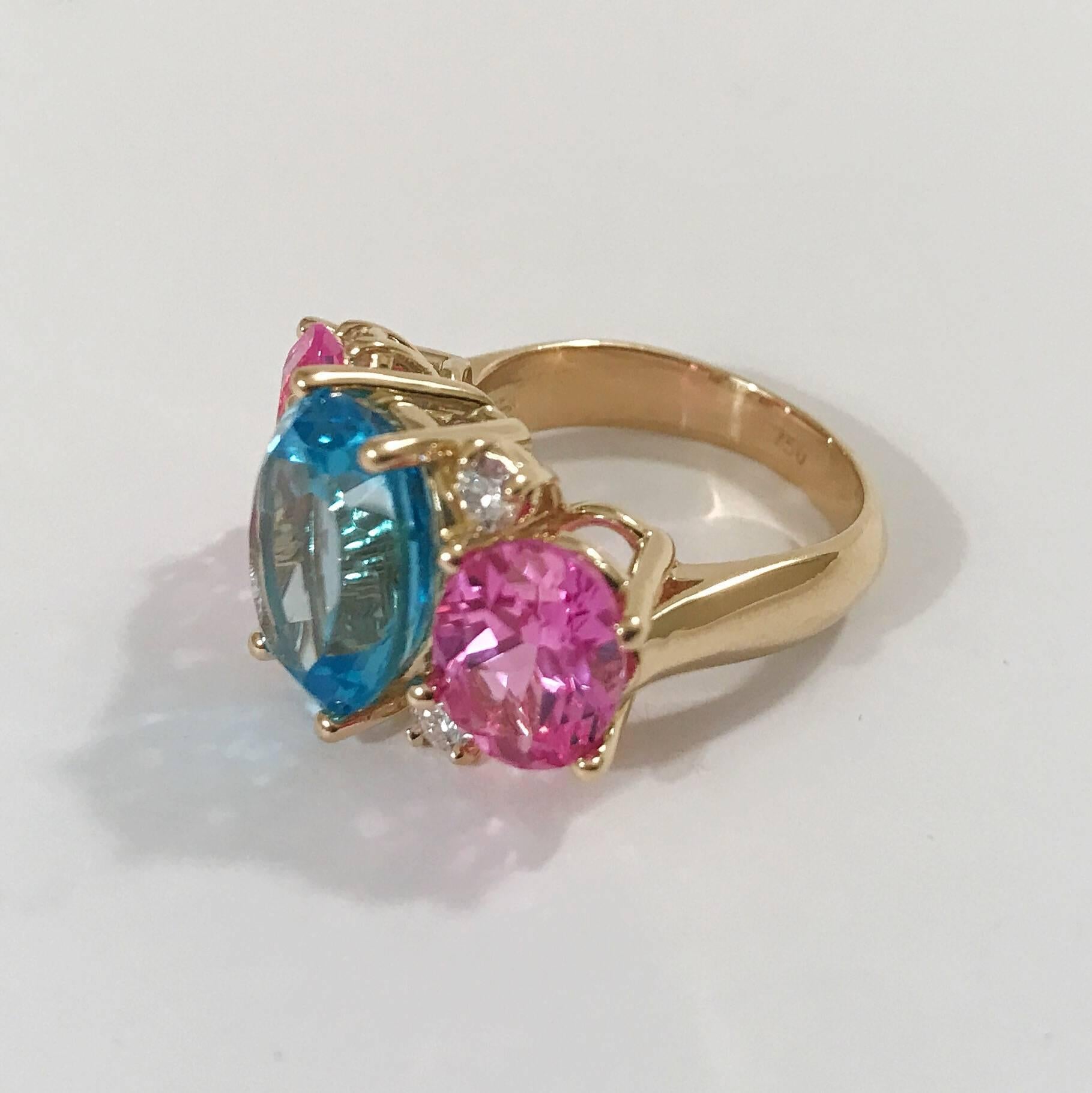 bague GUM DROP™ moyenne en or jaune 18kt avec topaze bleue centrale ovale à facettes et deux topazes roses ovales à facettes et quatre diamants ronds ~0,50 ct  La bague mesure ~ 1