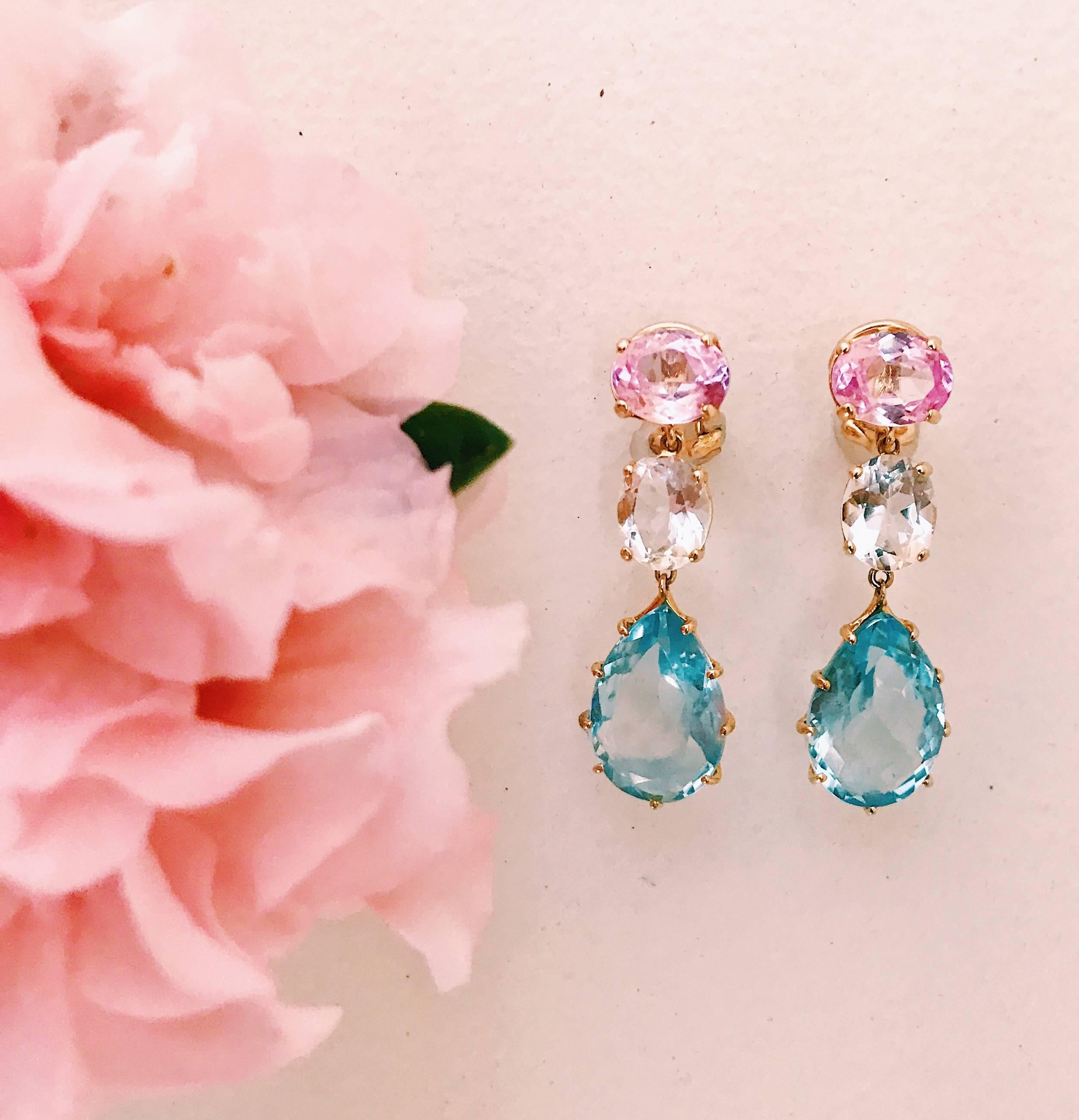18kt Yellow Gold 3-stone drop earring with faceted Pink Topaz, faceted rock crystal, and faceted Blue Topaz.

Clip omega back, can be posted or clip.

Specifications: Length: 1 5/8"

Please let me know if you have any