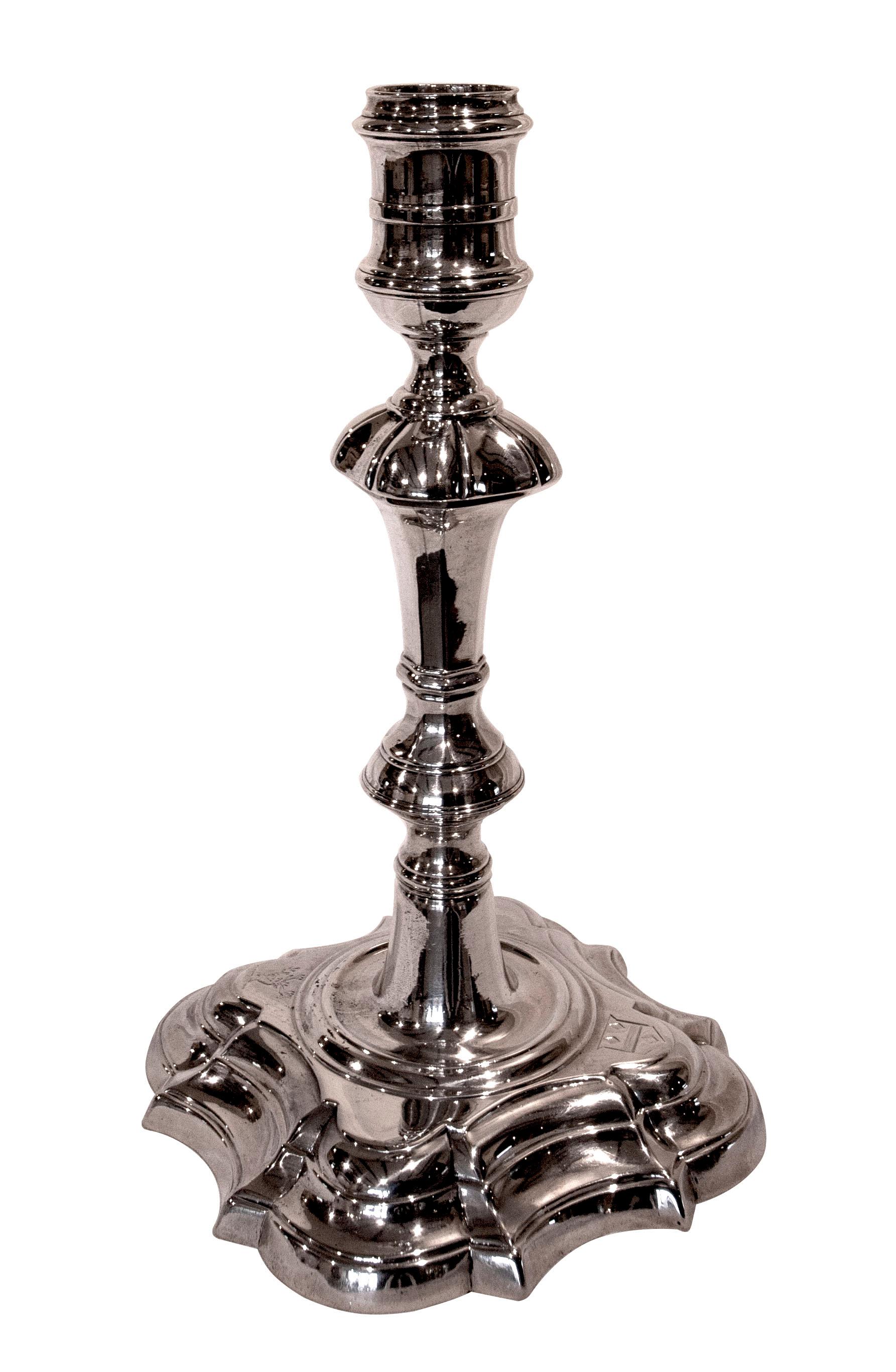 A set of four Georgian silver cast candlesticks each engraved with stags head crest and coat of arms.