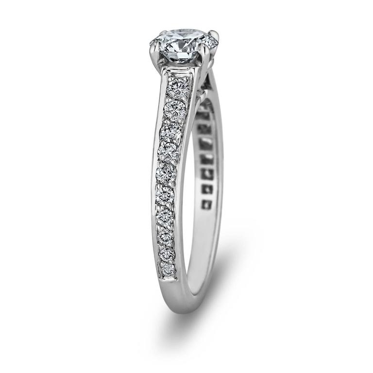 You will choose to shine when selecting this special Cartier Paris .65 round brilliant diamond engagement ring!  With 20 round side diamonds, weighing a total of approximately .18 carats, this ring represents one of the most precious gestures of