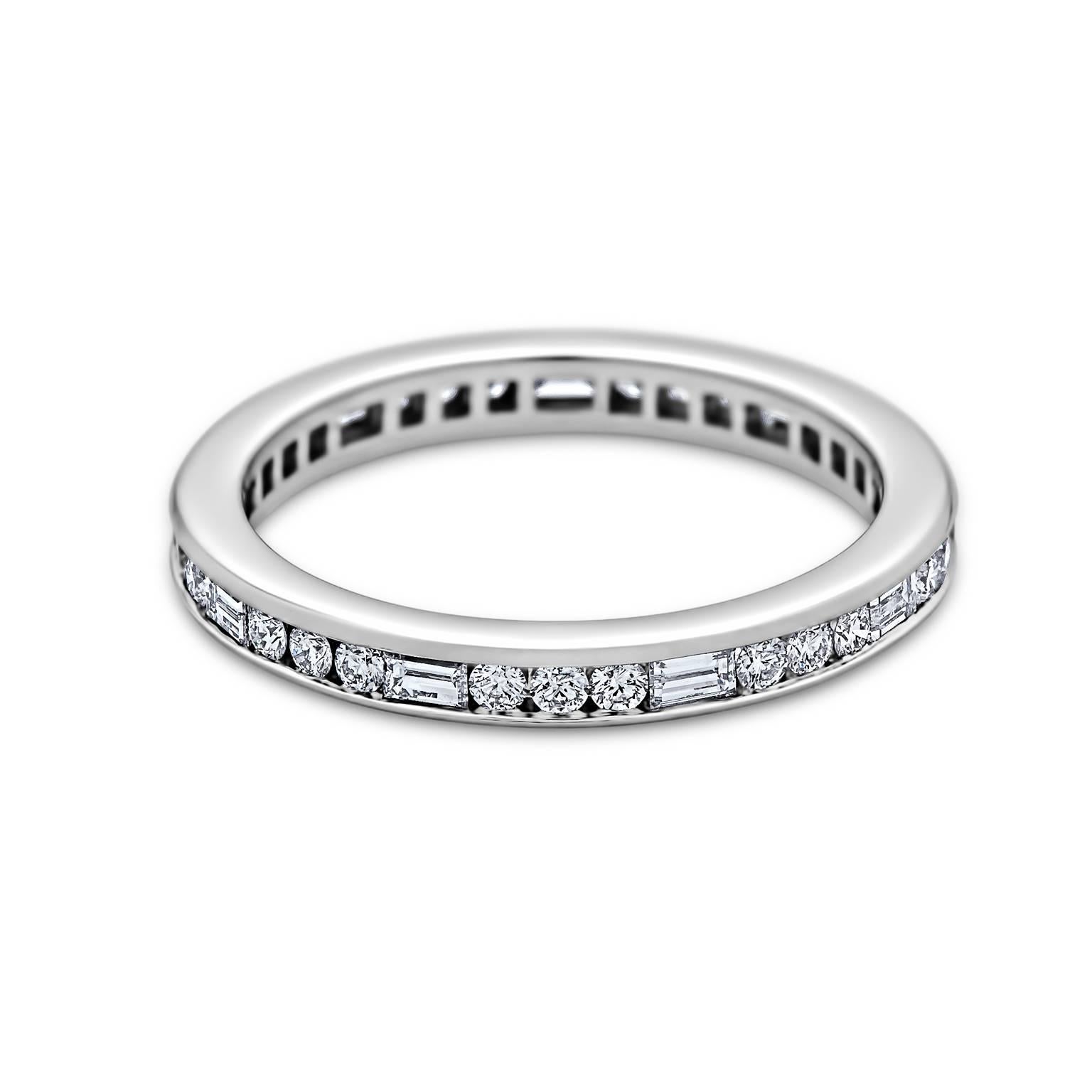 The perfect combination of round and baguette cut diamonds make this eternity band simply brilliant. Total round cut diamond weight .36 carats. Total baguette cut diamond weight .32 carats. D-F color. VVS clarity. Band is 2.5 mm wide. Size 6 1/4 US.