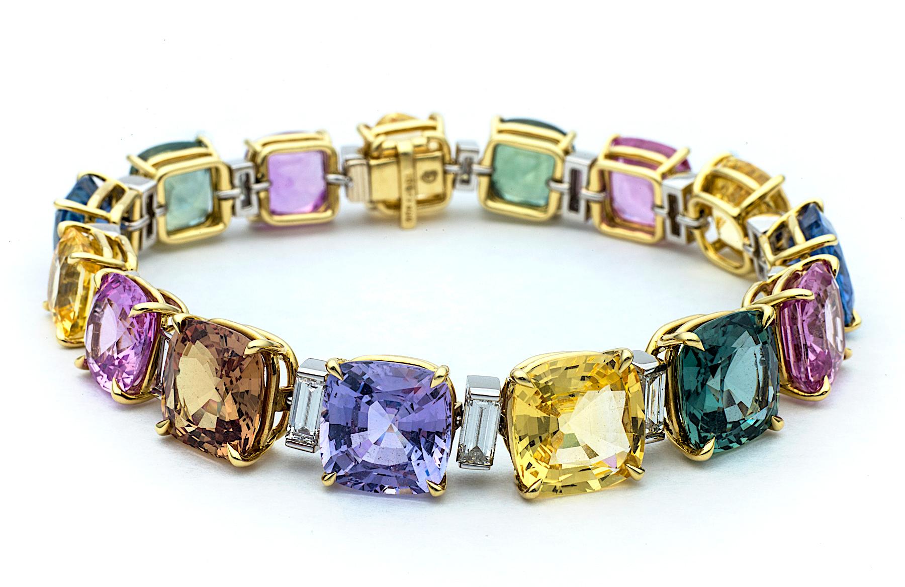 Looking like an irresistible array of gourmet candies, this colored sapphire bracelet is as sweet as it gets!  Consisting of 15 cushion cut sapphires, totaling approximately 59 carats in the heavenly hues of pink, yellow, purple, green, orange, and