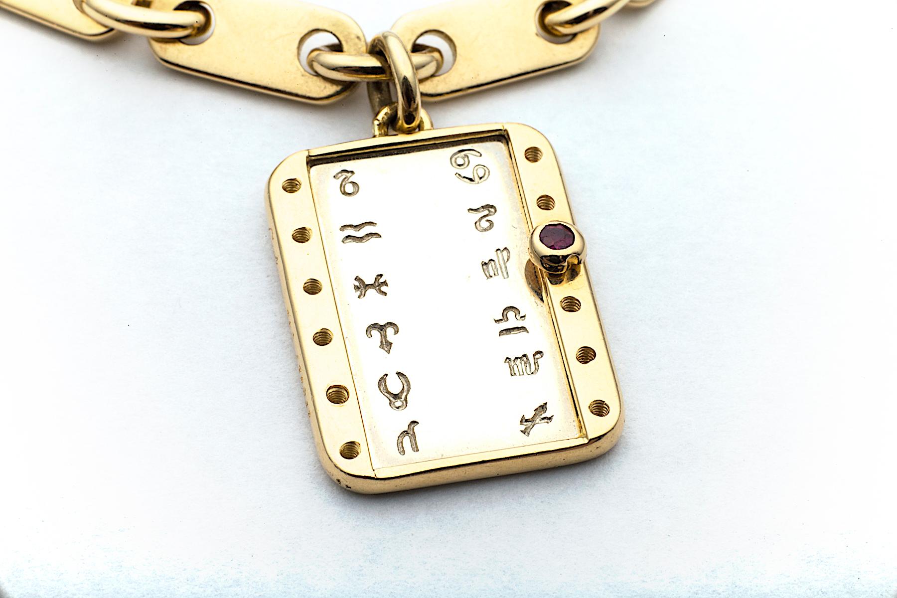 No matter what your Zodiac sign is this vintage 18 karat yellow and white gold Cartier link charm bracelet has your symbol covered.  The  round cut ruby bezel set marker on the rectangular charm can be moved to whatever beautifully engraved Zodiac