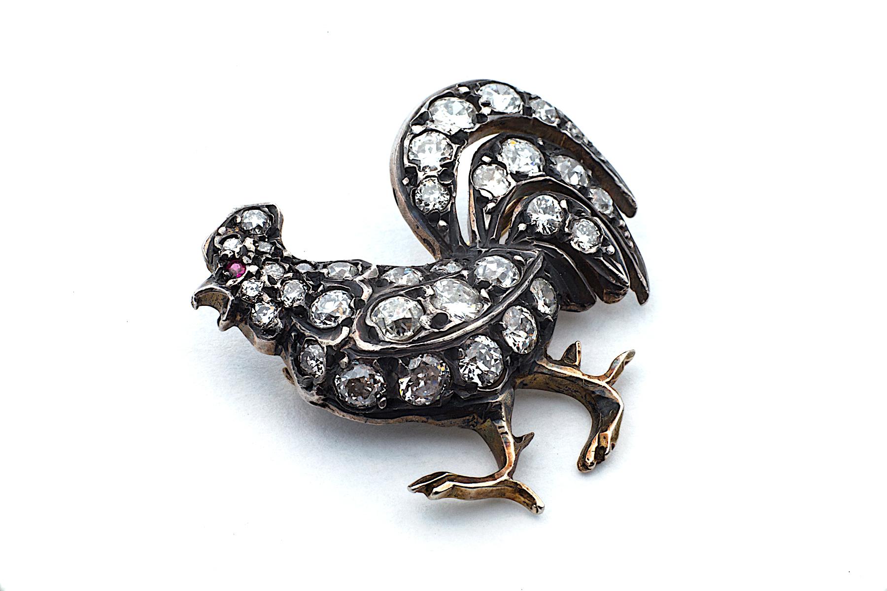 This beautifully designed and engineered French Victorian rooster brooch, with it's handsome plumage and confident stride, easily makes everyone smile!  With an embellished body of approximately one carat of single set round diamonds, this bird