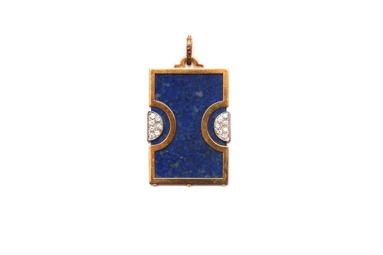 A sophisticated pendant presenting lapis and small brilliant cut diamonds (approximately 0.30ct total) on a fine 18kt yellow gold mounting.
