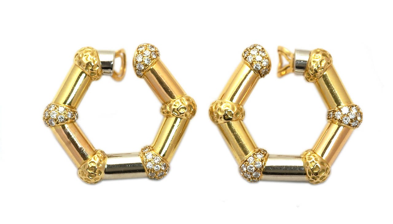 A rare pair of hexagonal design ear-clips; subtly mounted in white, yellow and rose gold; embellished by diamonds; dating back to the 1970s, made in France and retailed New York adding to the collectable allure of the item.  Signed Bulgari New York,