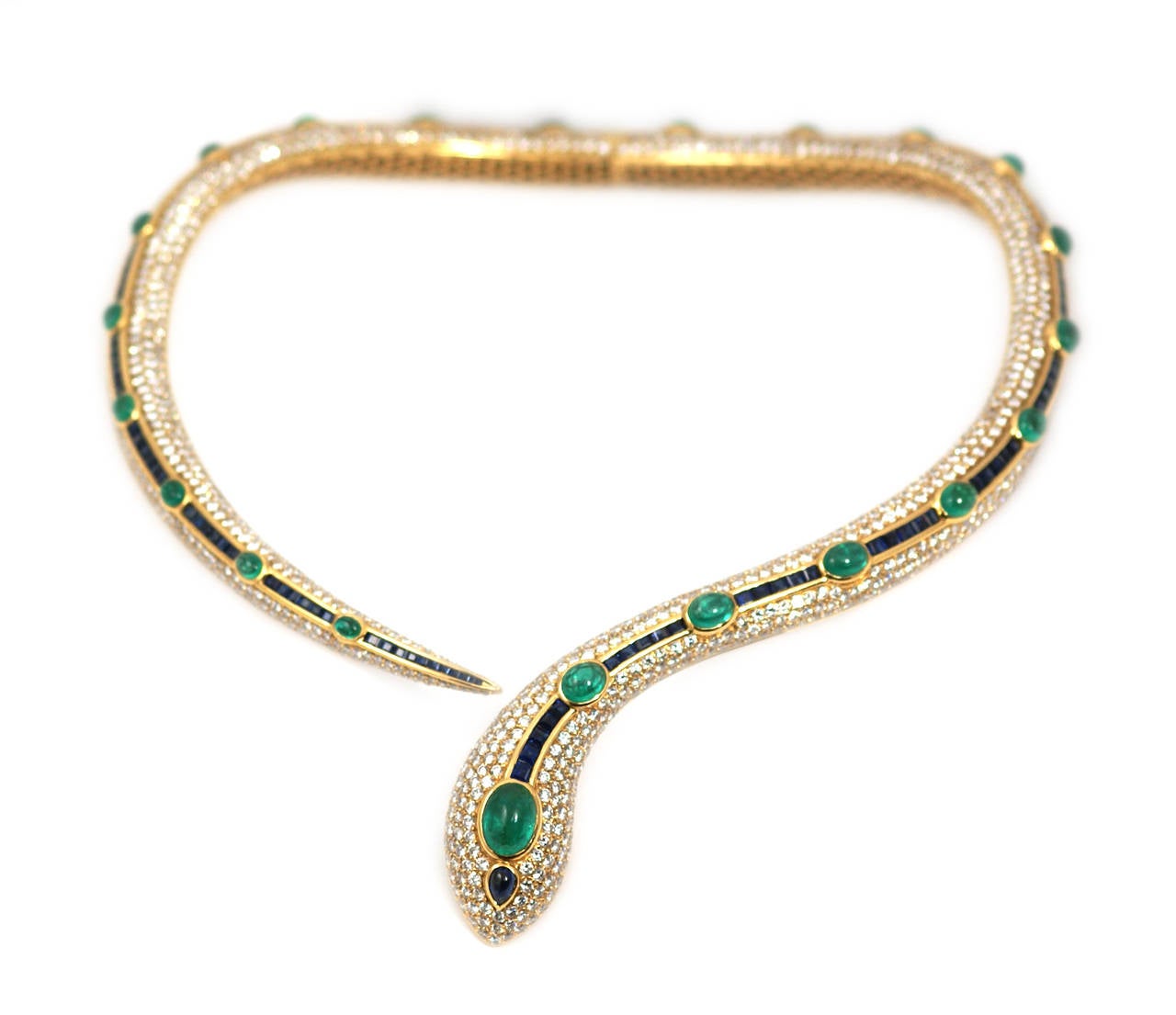 An important snake set comprised of necklace, bracelet and earrings; embellished by fine quality cabochon emeralds, sapphires and diamonds. Italy, circa 1980.