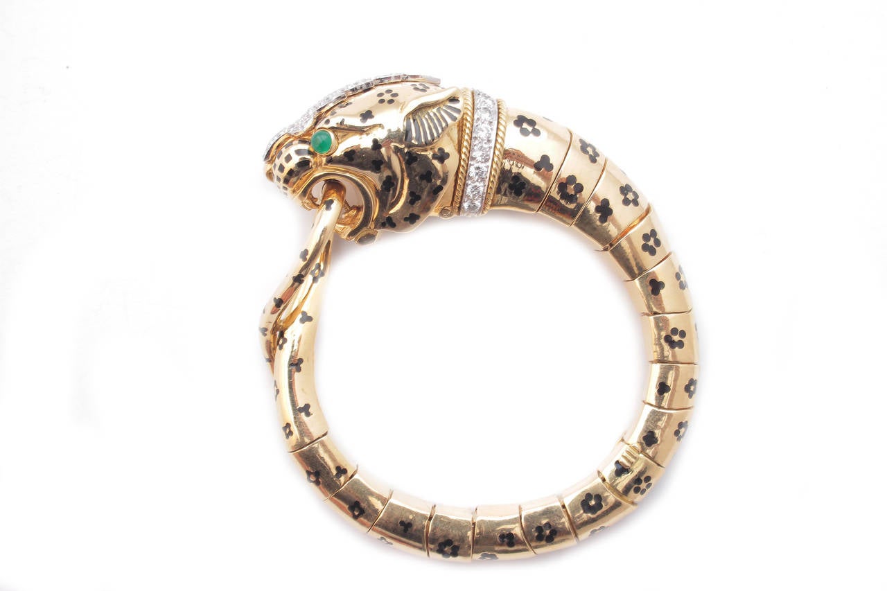 A bracelet from David Webb's Animalier collection representing a Tiger embellished by unusual floral decorations, fine brilliant cut diamonds, and emerald eyes. 18kt yellow gold mounting. Signed David Webb, circa 1975.