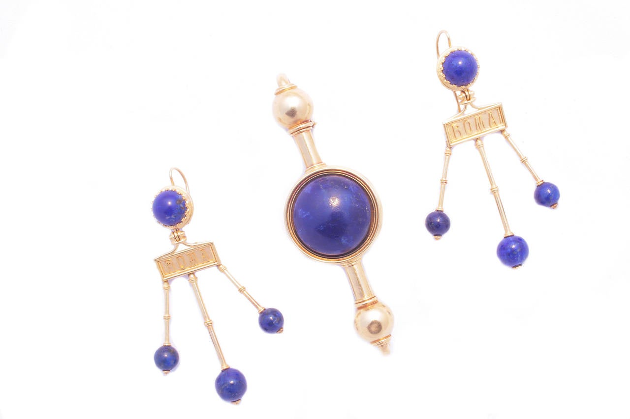 Comprising necklace, earrings and brooch, manufactured by the historic Roman jeweller Travaglini, embellished by spherical lapis-lazuli elements on a polished  yellow gold mounting typical of the time, marked 