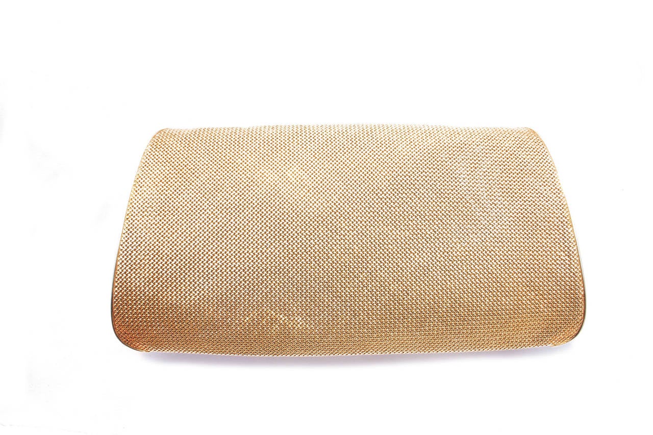 An unusual Two-Color Gold Evening Bag by Bulgari. The curved rectangular mesh case decorated with two-color fluid motif banding,  total gross weight approximately 360 grams, comprised of one compartment opposed by a mirrored panel, signed Bulgari,