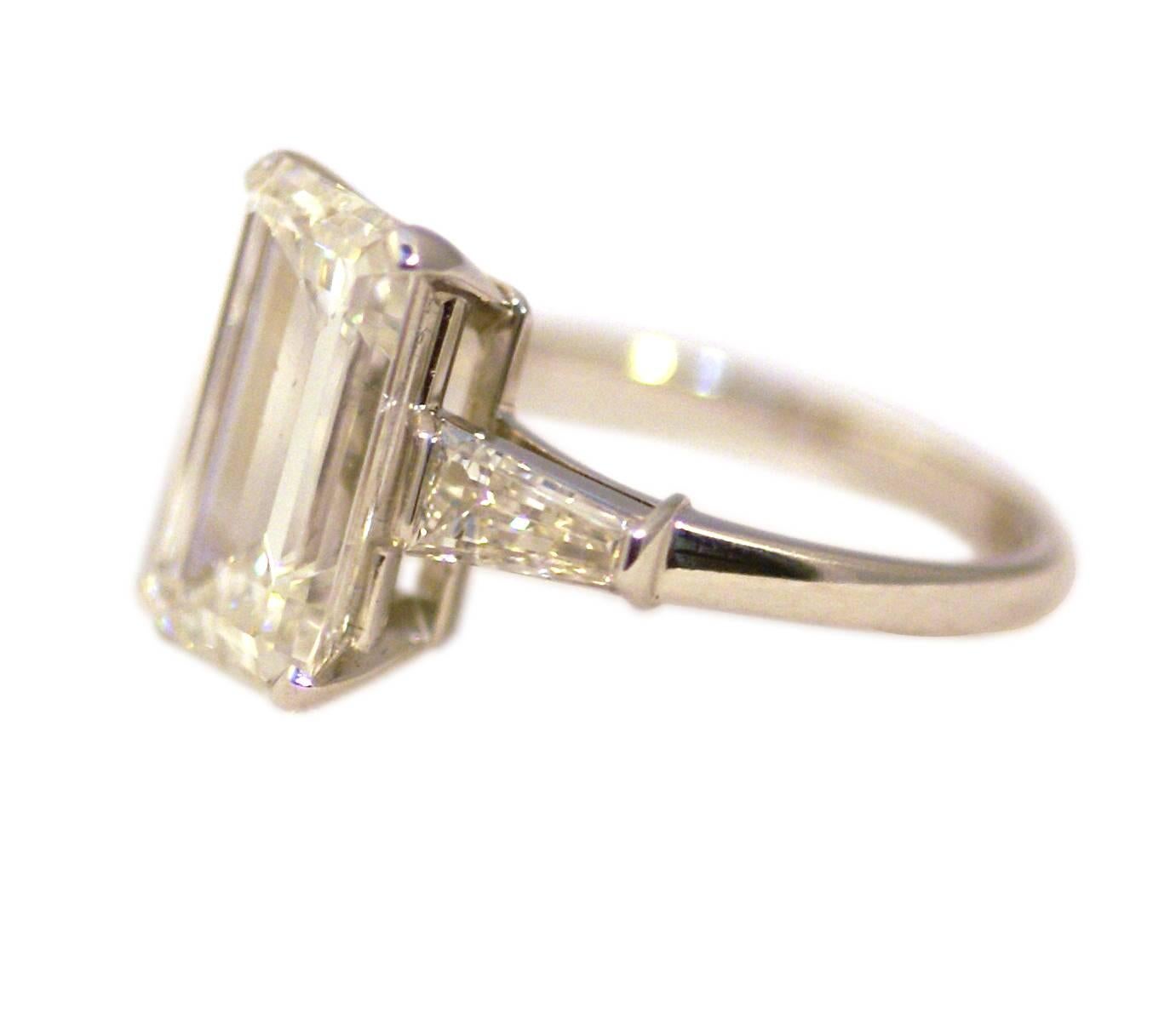 A 3.85 carat emerald cut, sided by two tapered baguettes, by Bulgari, circa 1980. G color, VVS1 clarity. 
