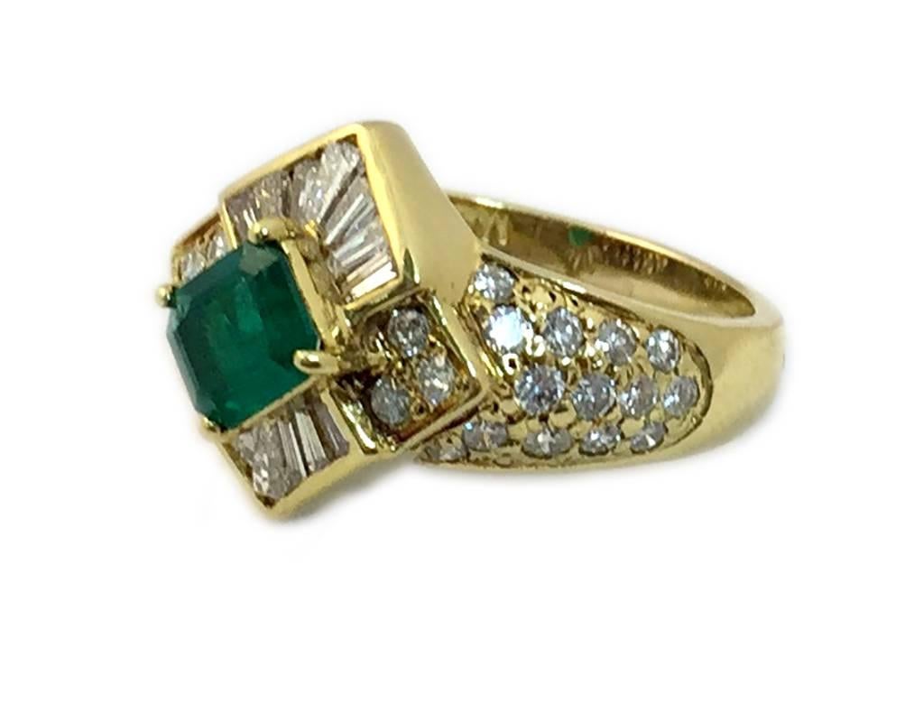 An 18kt yellow gold ring, embellished with mixed cut diamonds and showcasing a 1.50 ct emerald. Circa 1970 