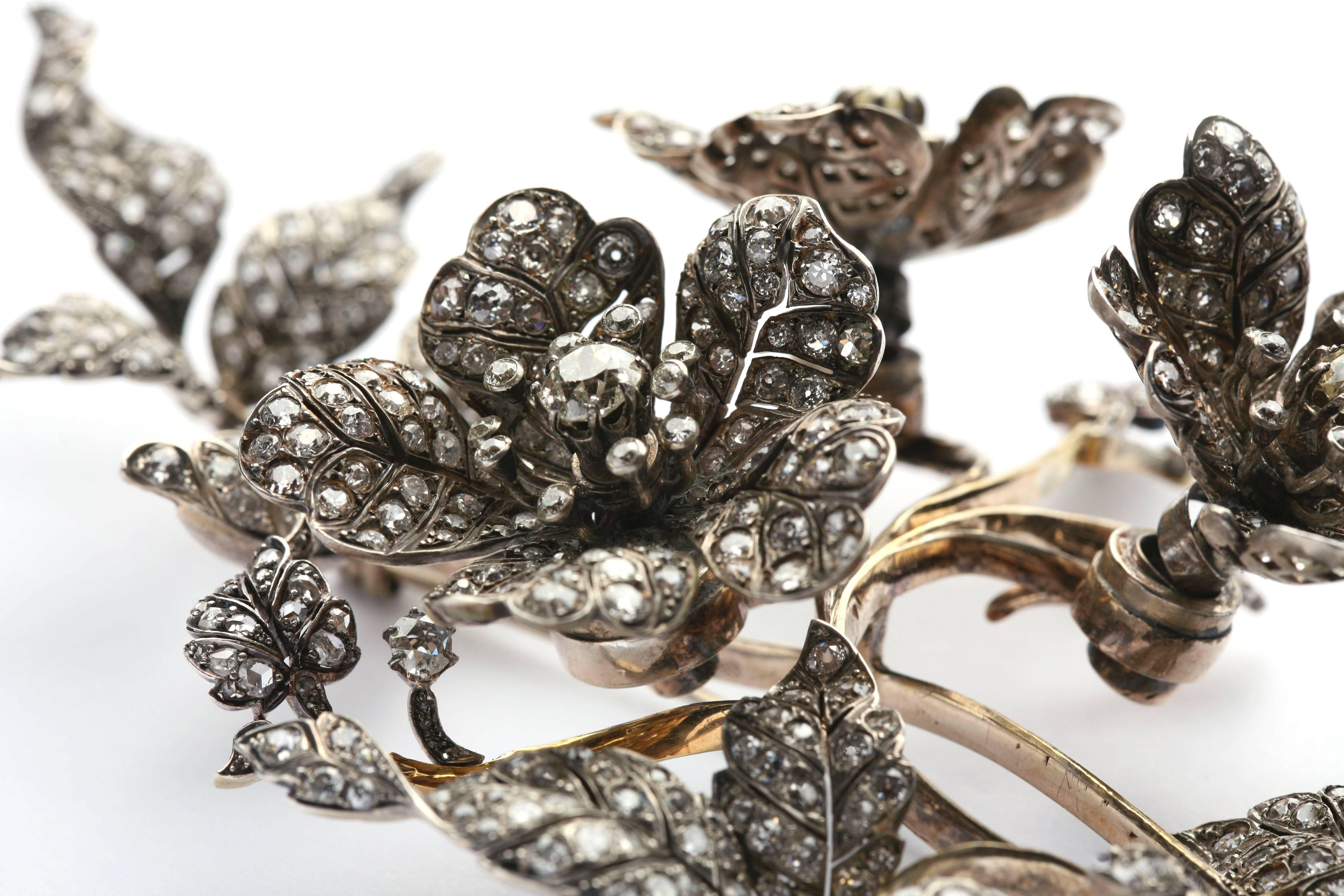 An impressive diamond branch brooch, dated late 19th century, the three main flower elements being mounted 