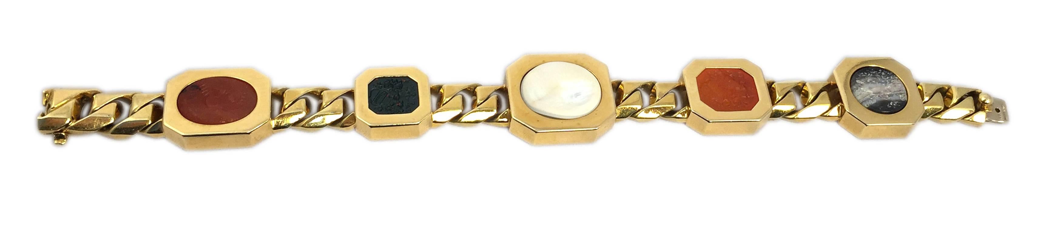 An unusual gold chain bracelet by Bulgari, presenting five fine 19th century  intaglios in hard stones such as diasper, blood stone and cornelian. Circa 1975