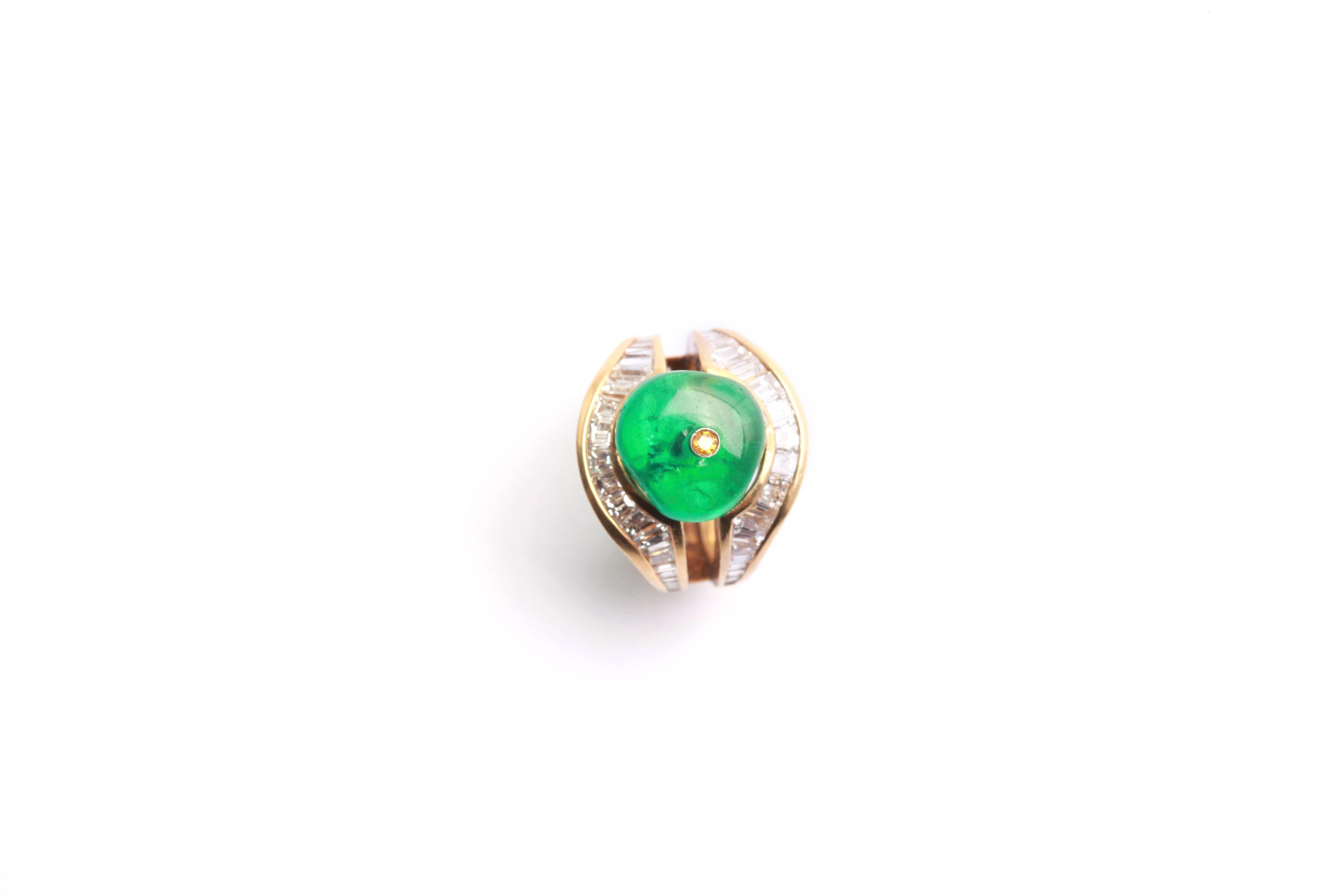 A peculiar cocktail ring in 18kt yellow gold, highlighted with baguette cut diamonds (apprx 3cts total), showcasing a fine Old Mine Colombian emerald bead weighing 9.03 carats. Circa 1970
