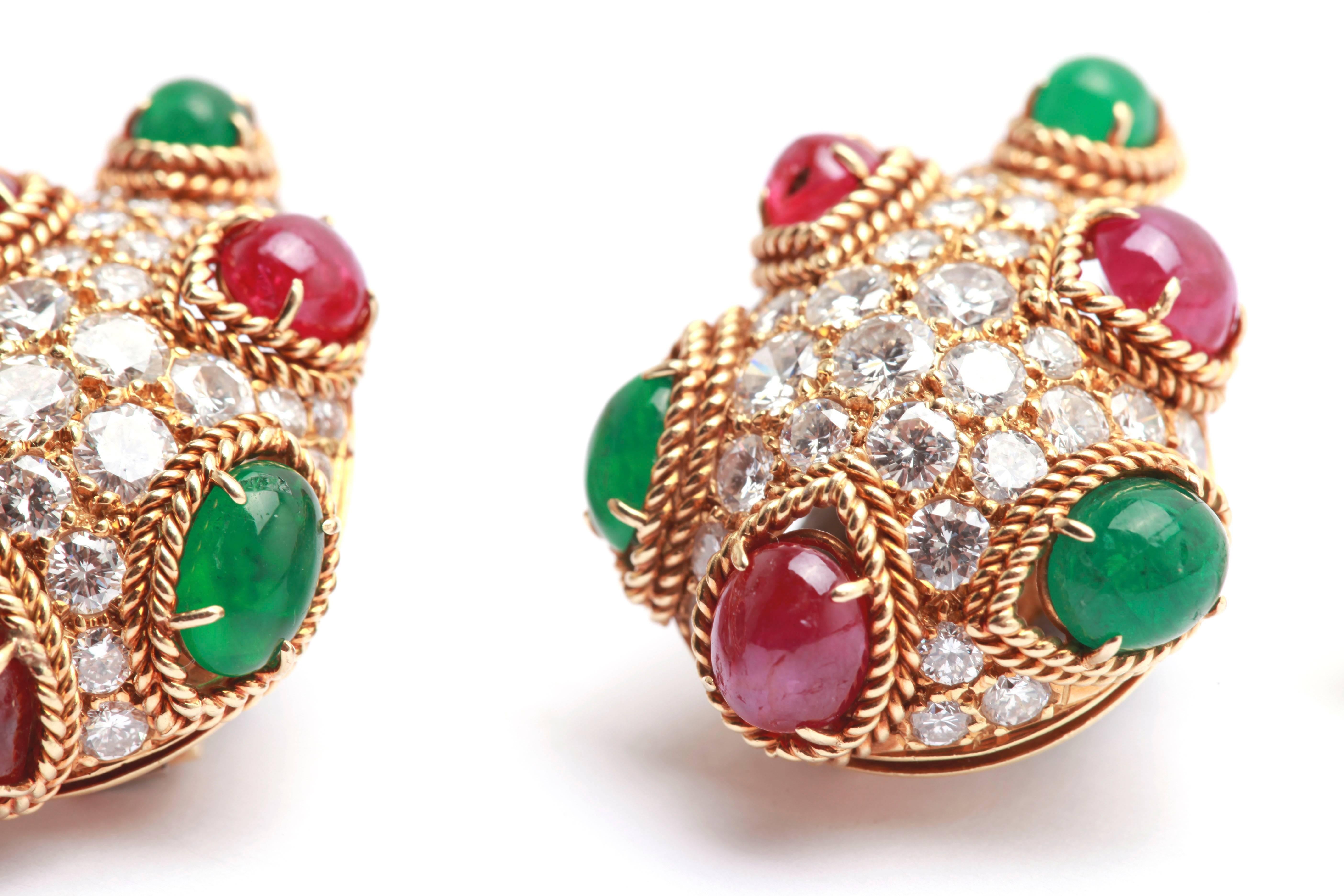 
A sophisticated and colorful pair of pear shaped ear clips by Van Cleef & Arpels, with fine brilliant diamonds, embellished by cabochon rubies and emeralds. Made in France, circa 1965.