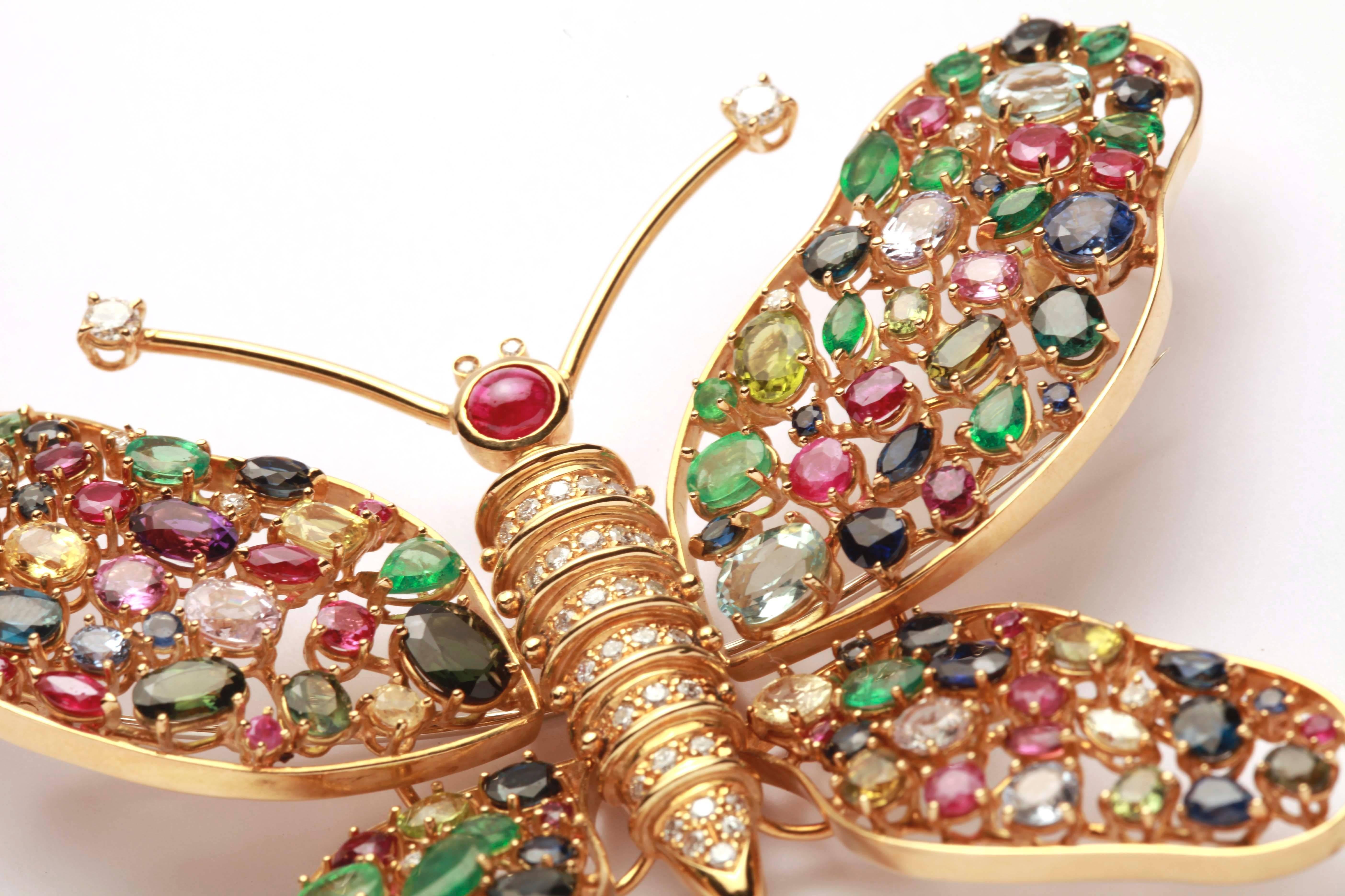 
An impressive and large 18kt yellow gold brooch resembling a Butterfly, encrusted with multicolor sapphires, rubies and emeralds. Circa 1980s