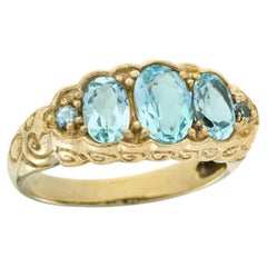 Oval Blue Topaz Three Stone Filigree Ring in 9K Yellow Gold