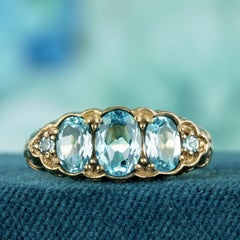 Oval Blue Topaz Three Stone Filigree Ring in 9K Yellow Gold