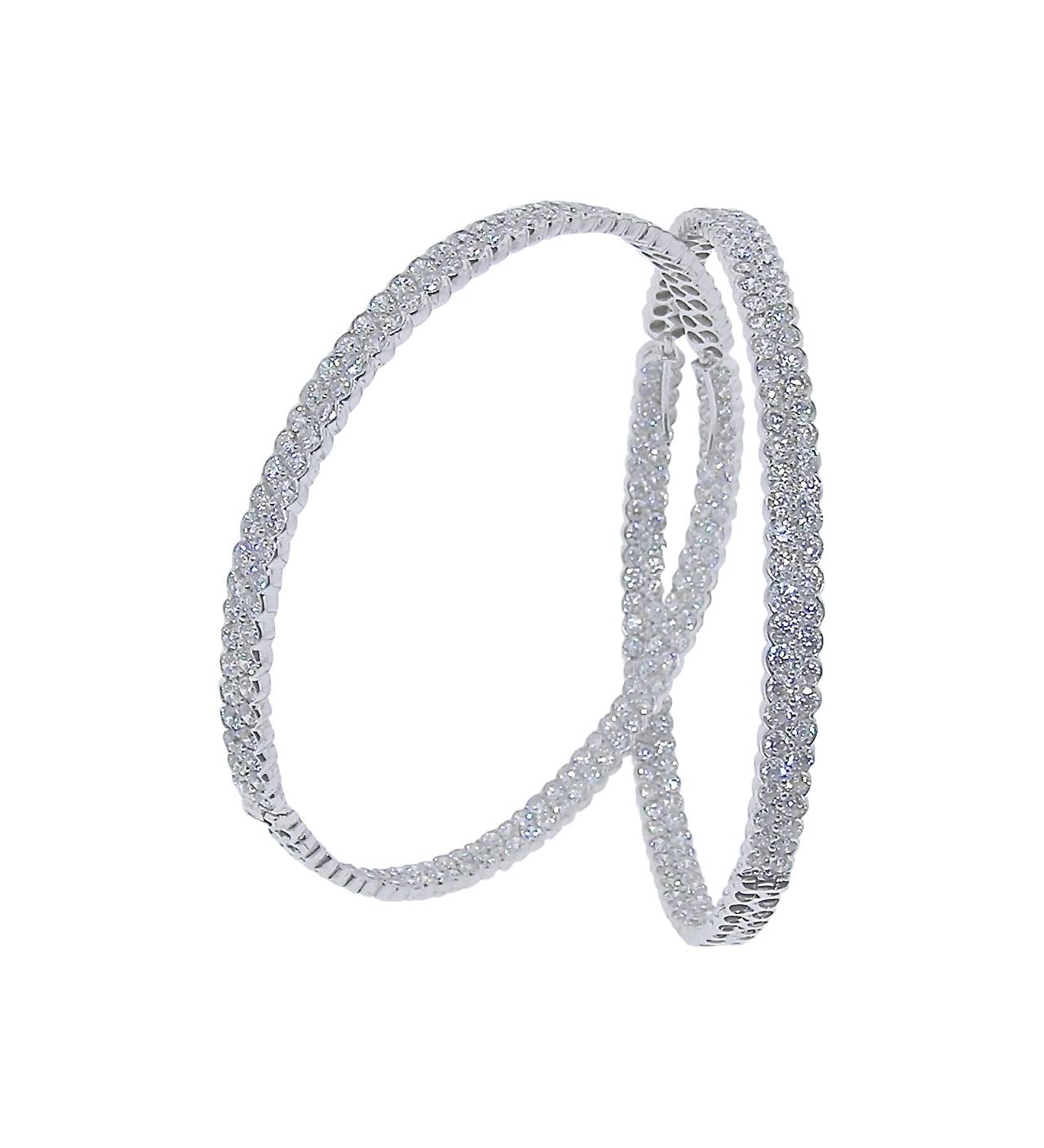 These 18K White Gold Hoops are 2 1/2 inches in diameter and feature nearly 15 Carats of Diamonds!  The two row earrings have Diamonds on the front and inside so you see Diamonds Diamonds Diamonds where ever you look!

Fabricated intricately so you