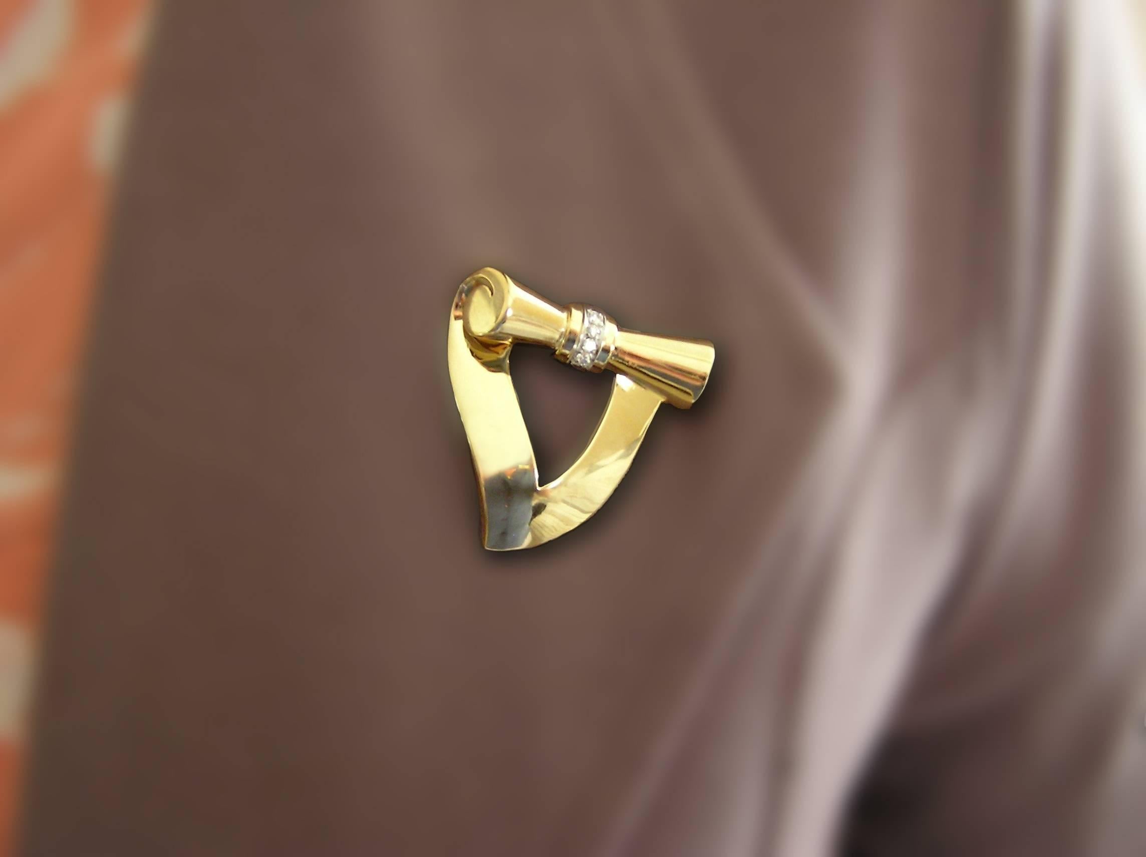 A wonderful 14K yellow gold retro diamond ribbon pin.  As new from the 1940's!  Accented with about .20 carats of G Color, VS1 Clarity diamonds. Strongly modeled with depth. A nice casual piece for daytime wear, as well as evening. About 1 1/4