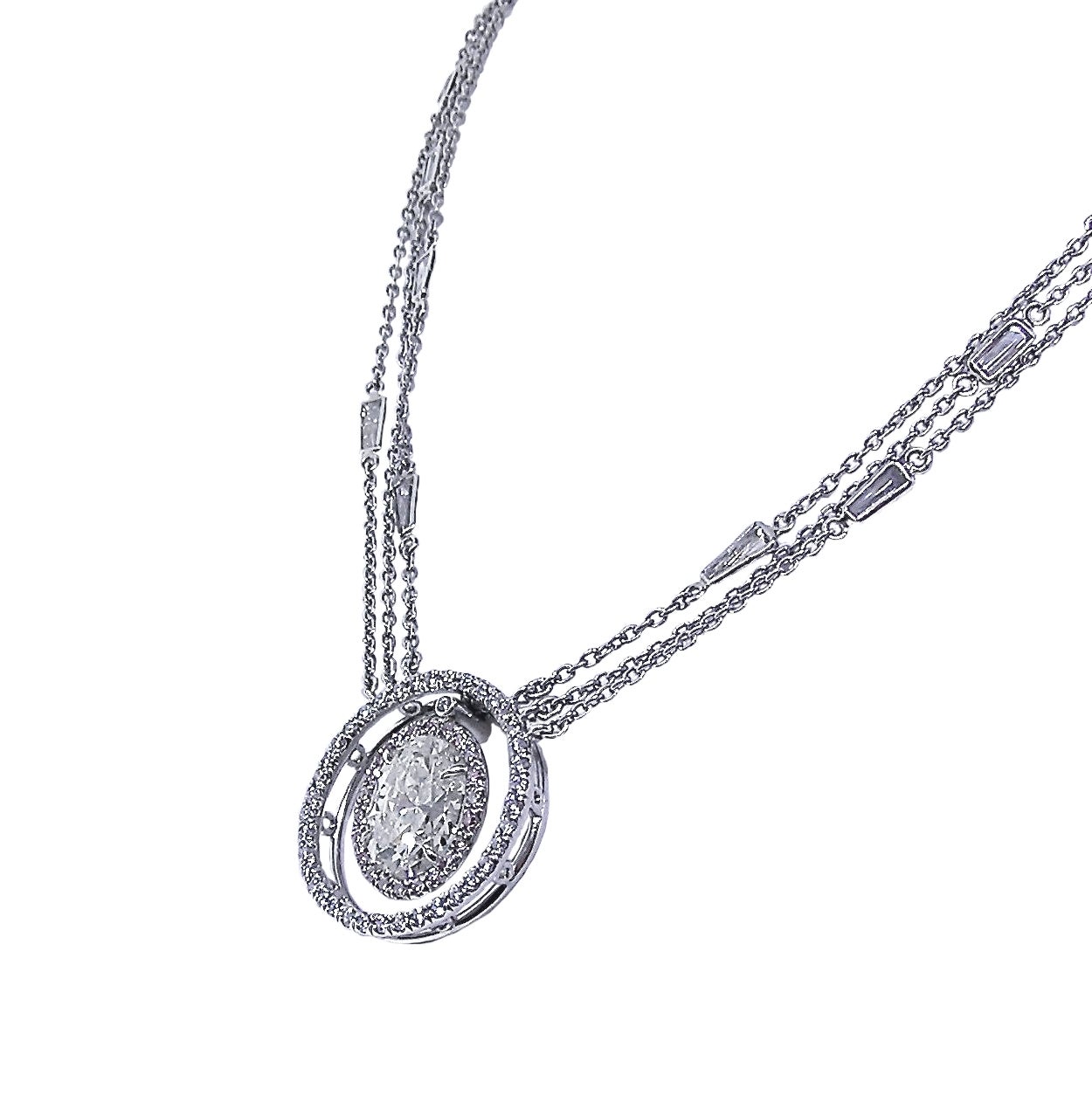 The platinum piece has a 2.50 Carat oval cut diamond dangling at center.  Surrounded by natural Pink Diamonds as well as White Diamonds. The 18 inch  trio platinum chain accented with bezel set baguette cut Diamonds. Total weight in diamonds is 4.58