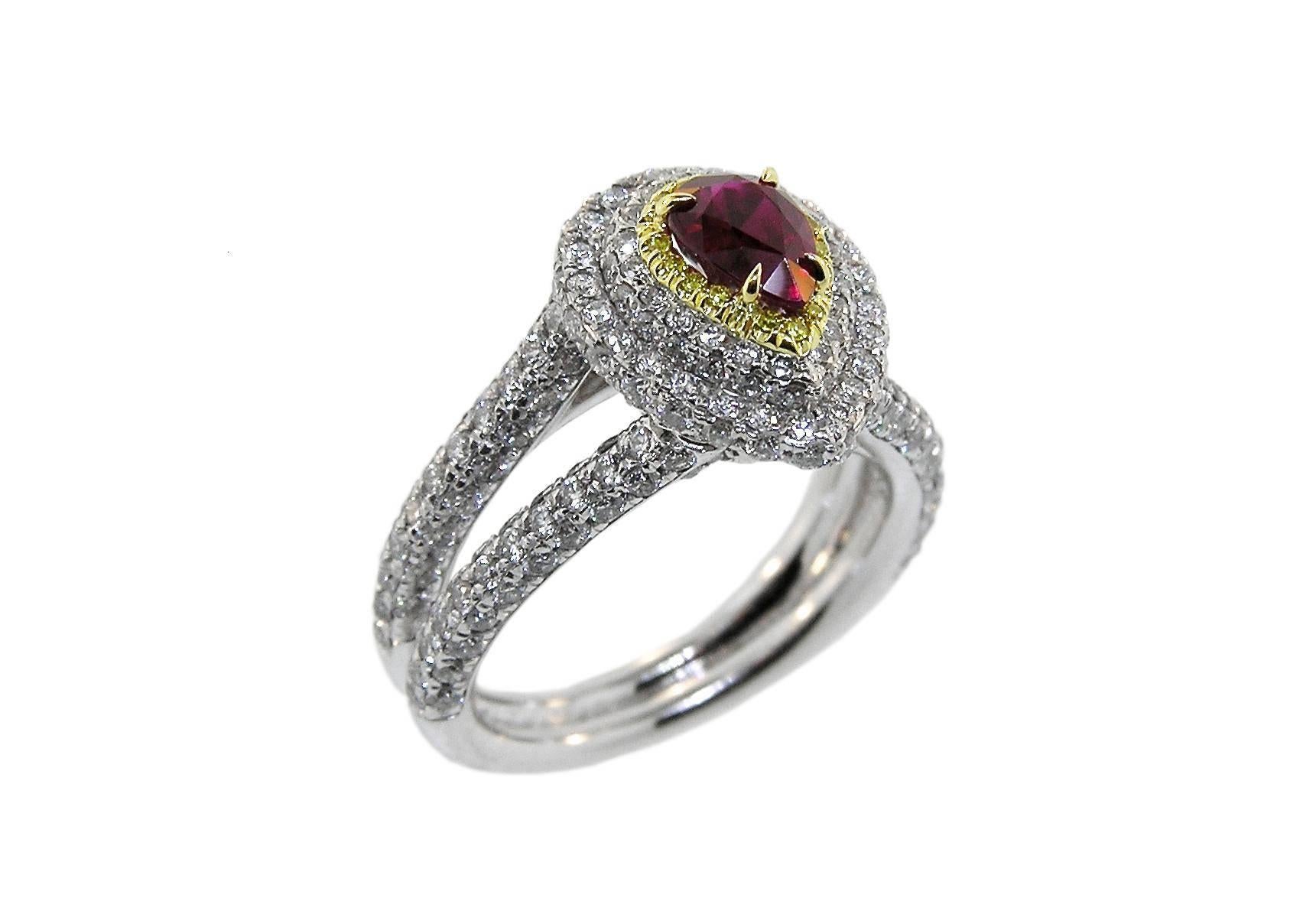 This ring, fabricated in our workshop, features a 1.02 Carat Ruby of exceptional color with flashes of bright red.  It is surrounded by a halo of Natural Canary Diamonds and several tiers of D Color White Diamonds.  Total weight in Diamonds is 1.91