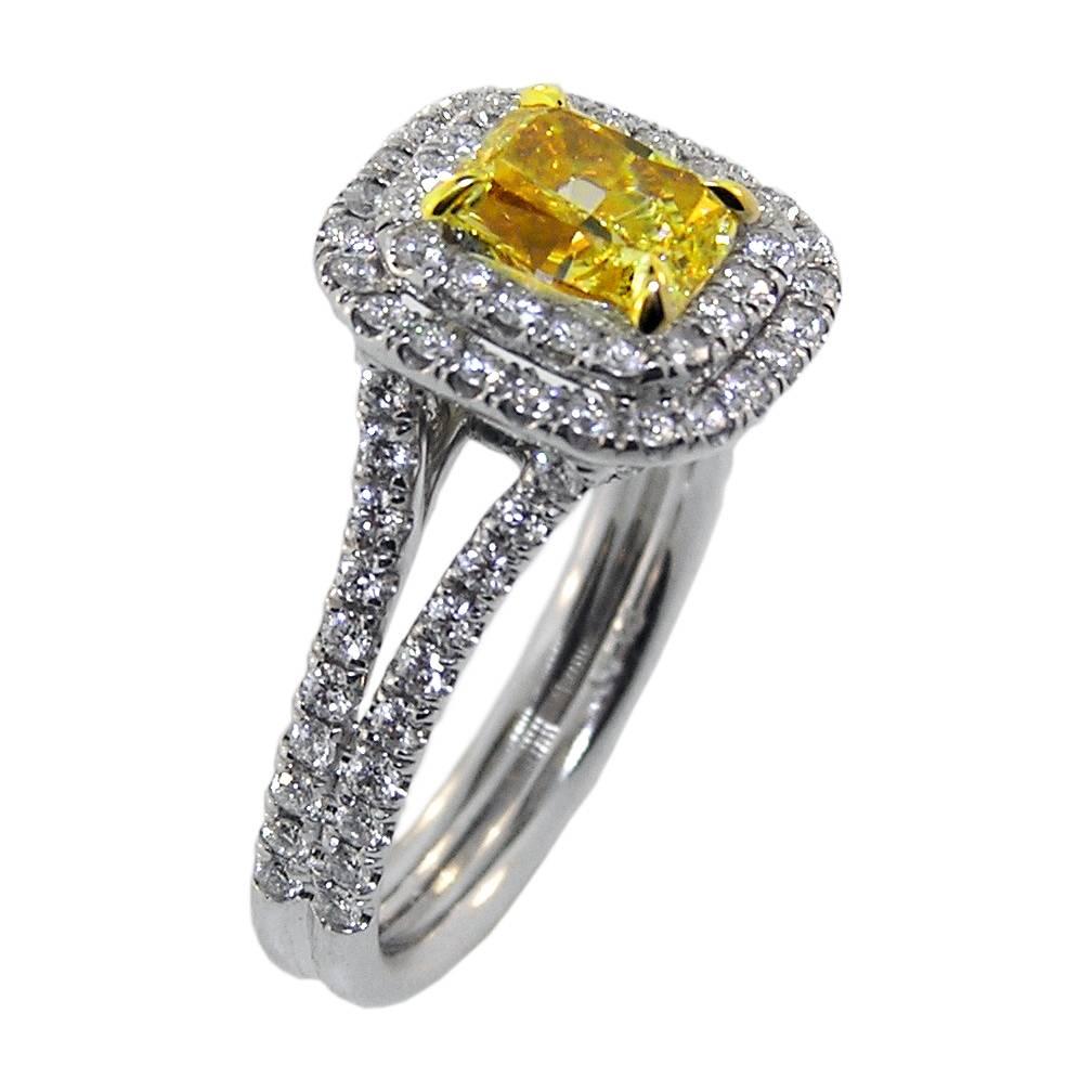 Featuring a scintillating 1.57 Carat Radiant cut Natural Canary Diamond.  The ring with .91 Carats of D Color White Diamonds.  Fabricated in Platinum in our workshop.