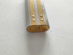 Accendino Cartier vintage in metallo con finitura oro e argento e strisce verticali
