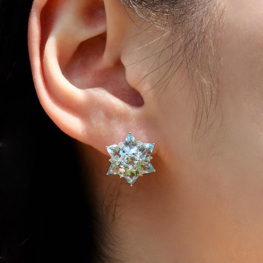 Discover Nina Zhou 4.80ct Aquamarine and 0.18ct Diamond Snowflake Earrings in 14k White Gold. These earrings are a celebration of the season's magic, capturing the essence of glistening snowflakes in a mesmerizing design. Each earring features a