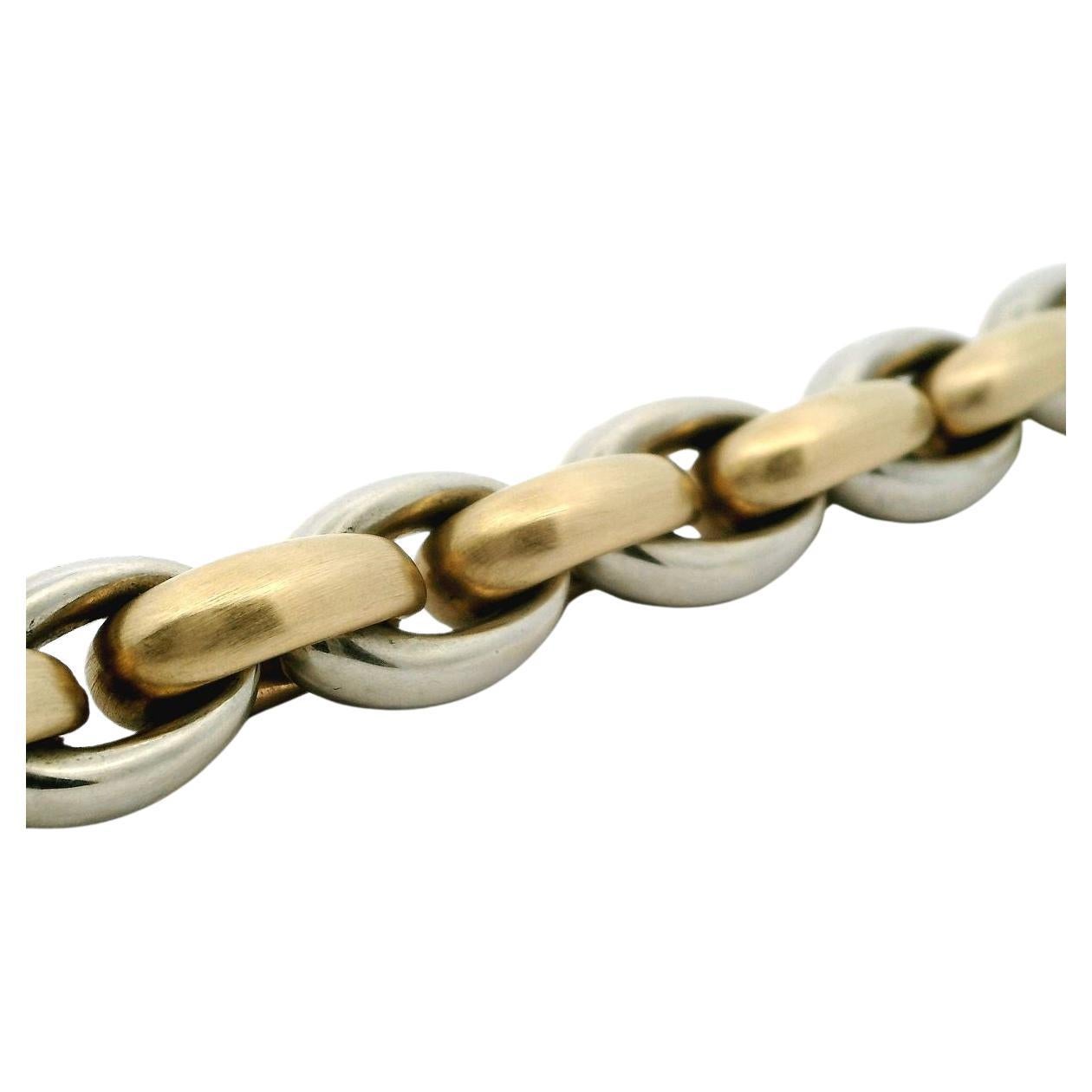 Dress up your off-duty looks with our Italian made 14 karat two-tone yellow and white gold chunky oval link bracelet offered by Alex & Co. This classic and timeless Circa 1980's piece features alternating white high polished and yellow satin finish