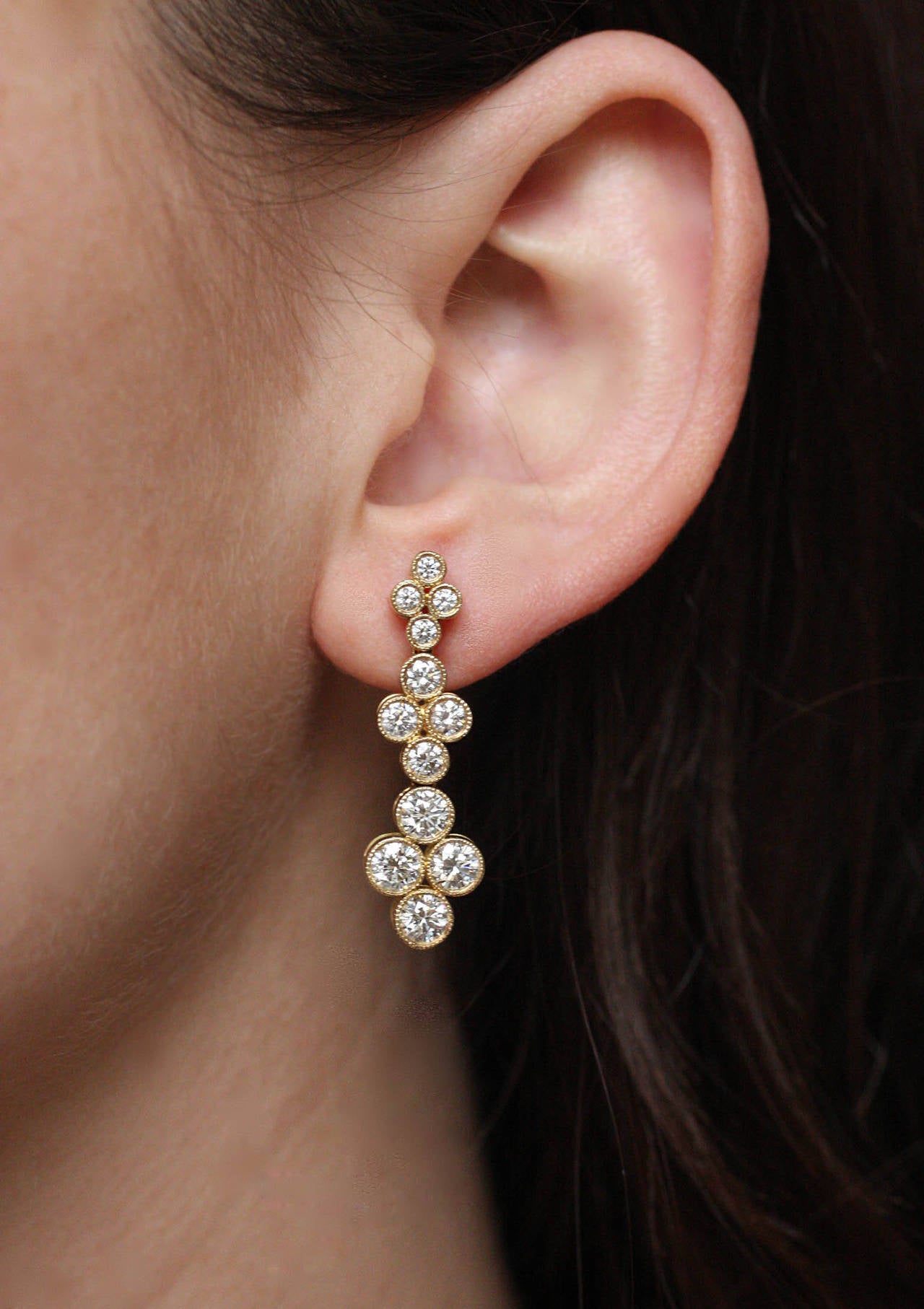 These beautiful earrings contain 24 brilliant cut diamonds weighing 2.81 Cts., are accented by fine milgrain detail, and are very flexible.  They measure 1 3/8