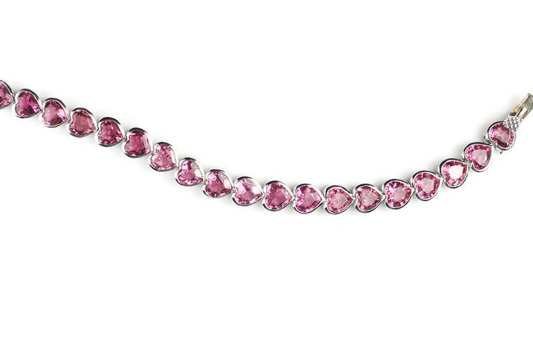 This beautiful, flexible bracelet contains 26 Heart Shaped Pink Tourmalines, equaling 15.96 Cts., set in Platinum bezels.  

6 3/4