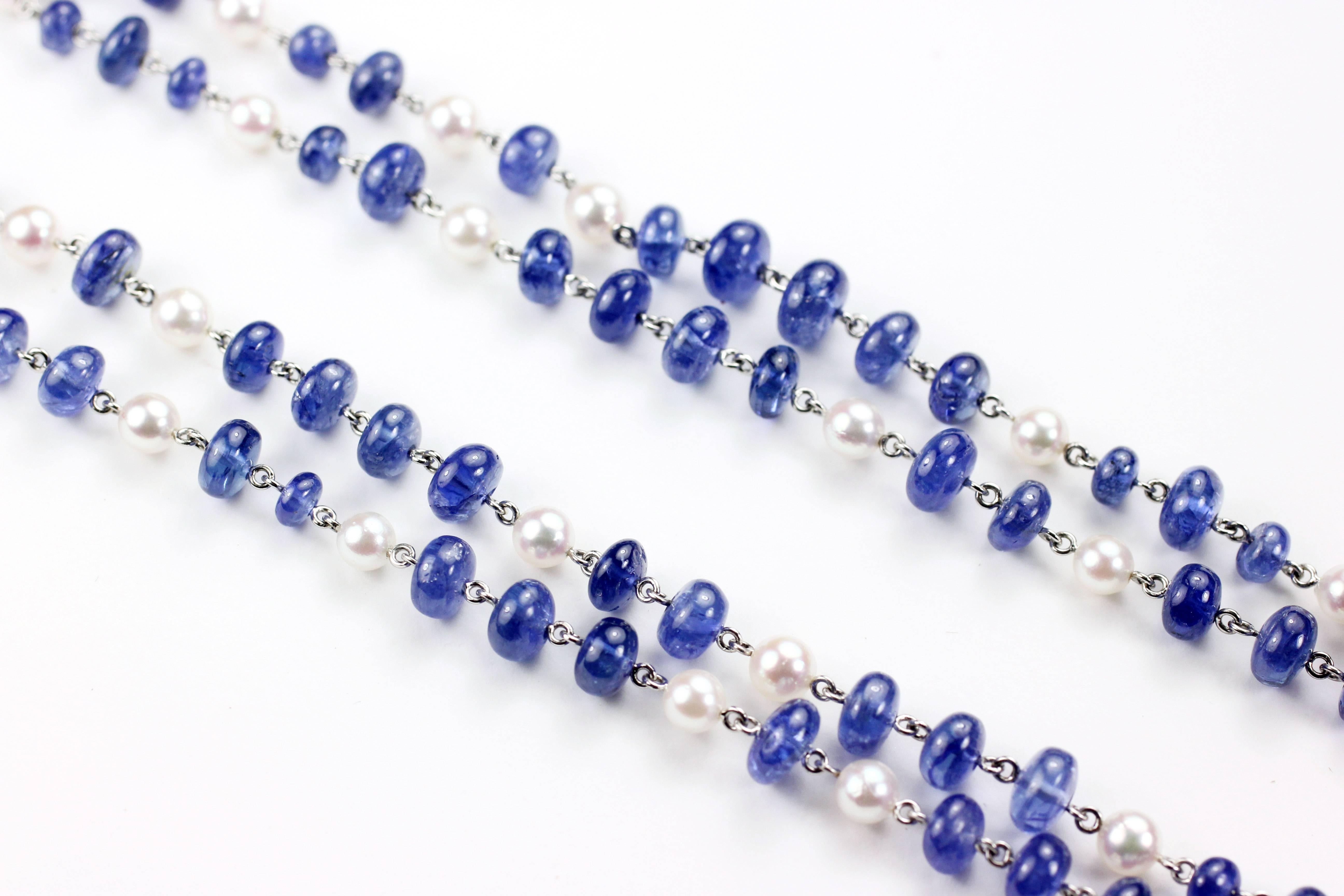 This long Sapphire Bead and Pearl Chain Necklace measures 42 1/2 inches. It contains 136 Sapphire Beads weighing 121.21cts and is interspersed with 55 Pearls.  The connections are made by hand in platinum.  

Designed and made in house by Julius