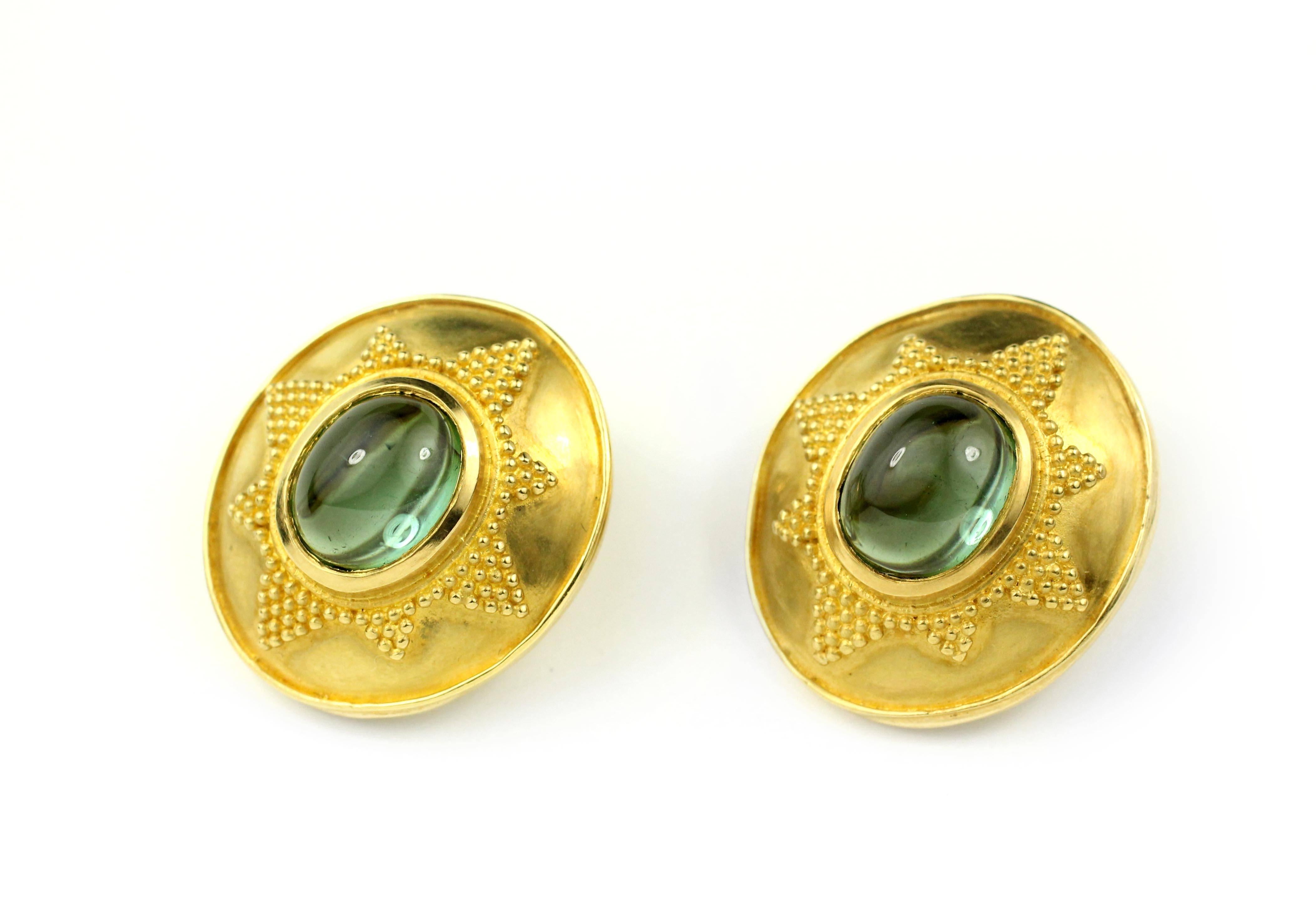 These beautiful green tourmaline cabochons (8.20 Cts.) are surrounded by lustrous 22 Kt Gold settings.  Clip backs are constructed of 18 Kt Gold for added strength and durability.  

Designed and made in house by Julius Cohen New York